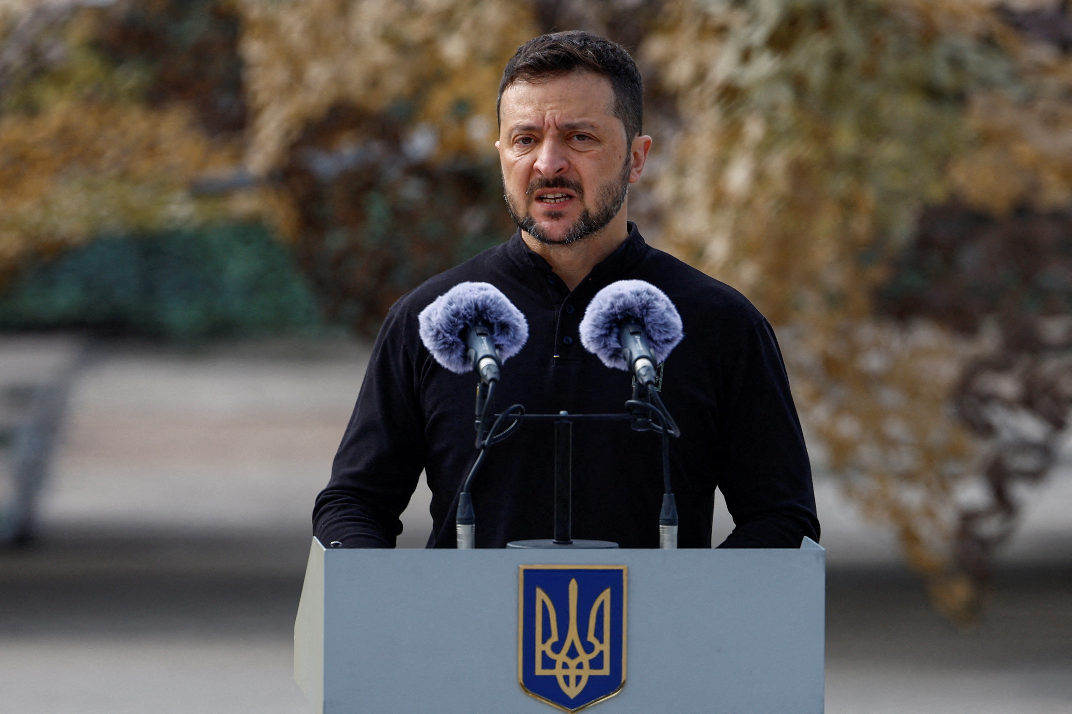 Ukraine's President Zelenskiy speaks next to service members next to F-16 fighting aircrafts during marking the Day of the Ukrainian Air Forces in an undisclosed location in Ukraine