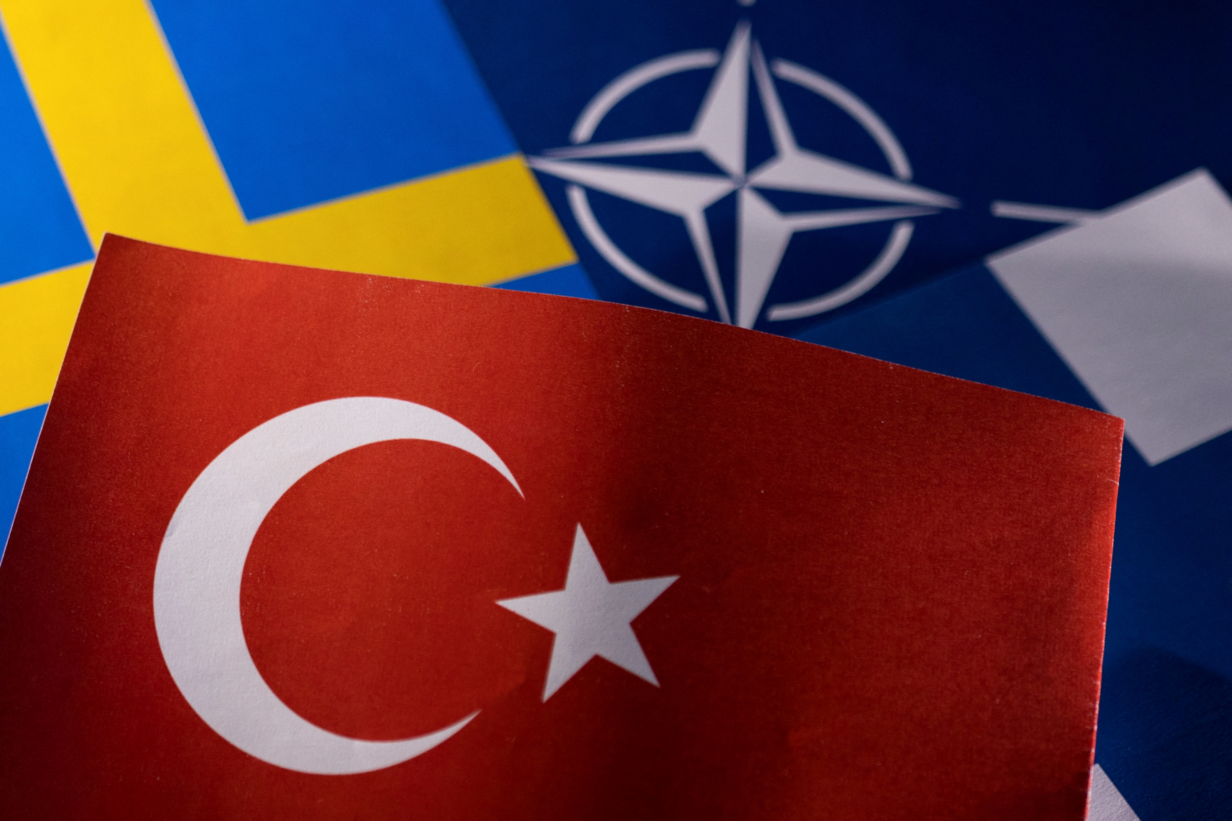 Illustration shows NATO, Turkish, Swedish and Finnish flags
