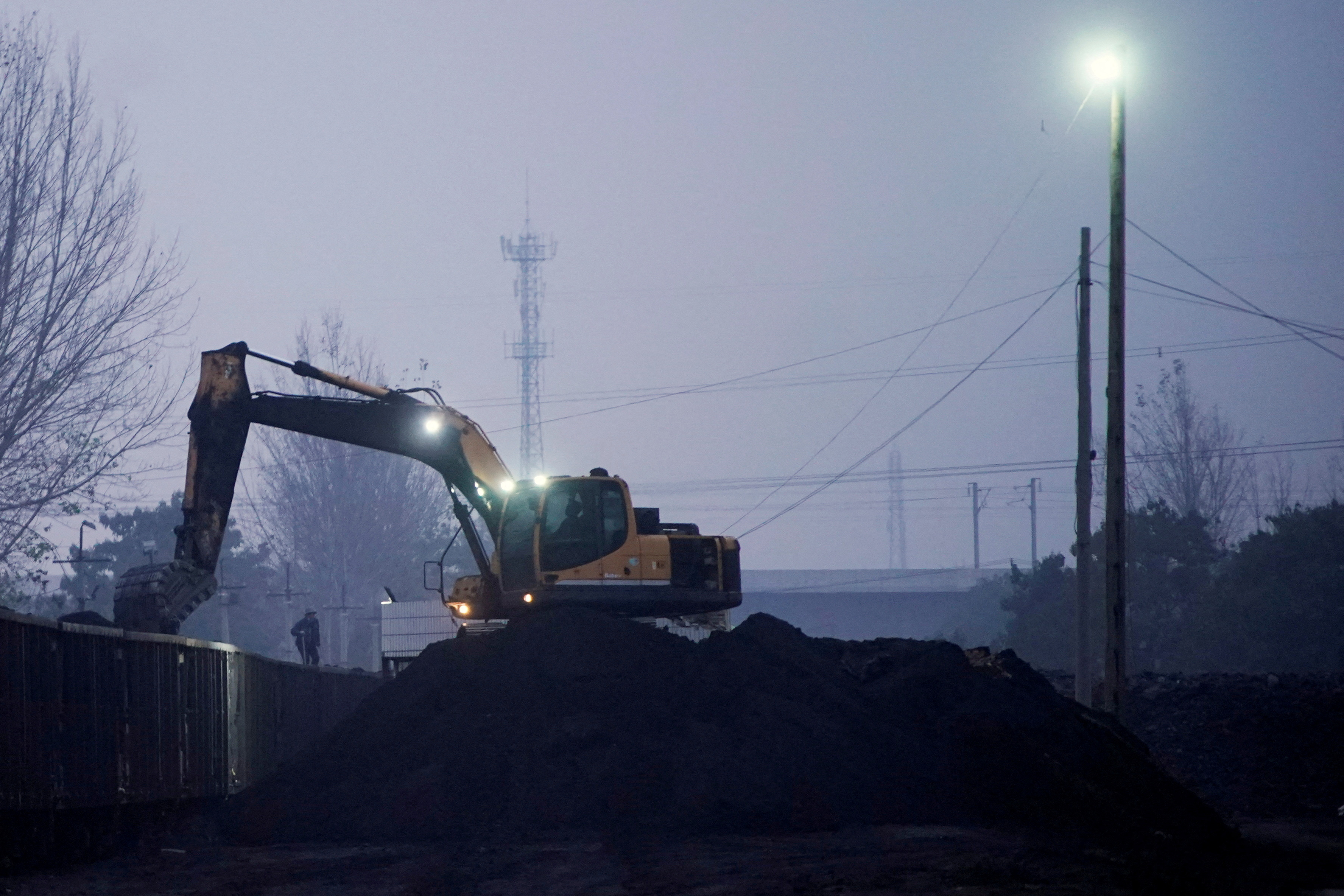 Excavator loads coal to a train in Pingdingshan