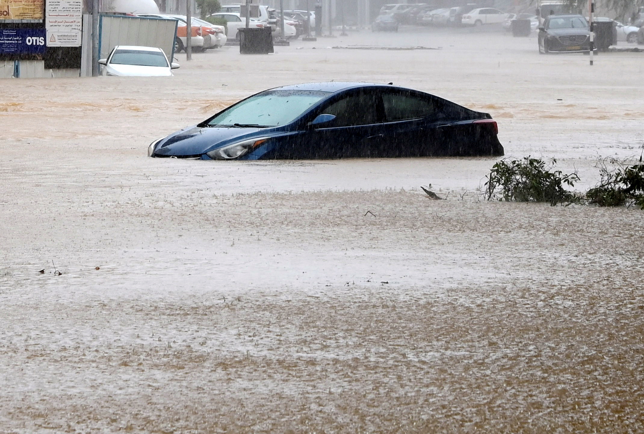 A car is partially submerged on a flooded street as Cyclone Shaheen makes landfall in Muscat Oman, October 3, 2021. REUTERS/Sultan Al Hassani