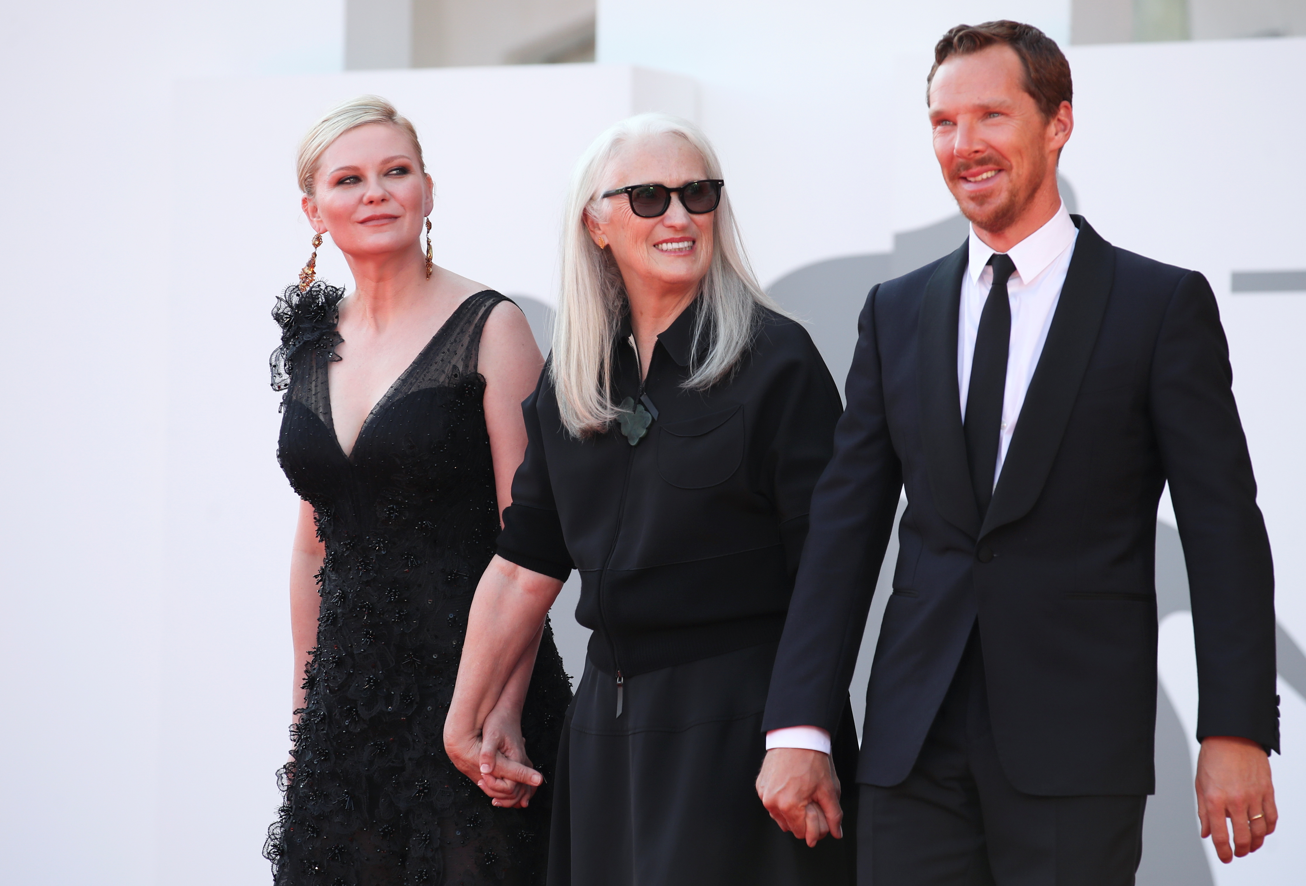 The 78th Venice Film Festival - Screening of the film 'The Power of the Dog' in competition - Red Carpet Arrivals - Venice, Italy September 2, 2021 - Actor Kirsten Dunst, director Jane Campion and actor Benedict Cumberbatch pose. REUTERS/Yara Nardi
