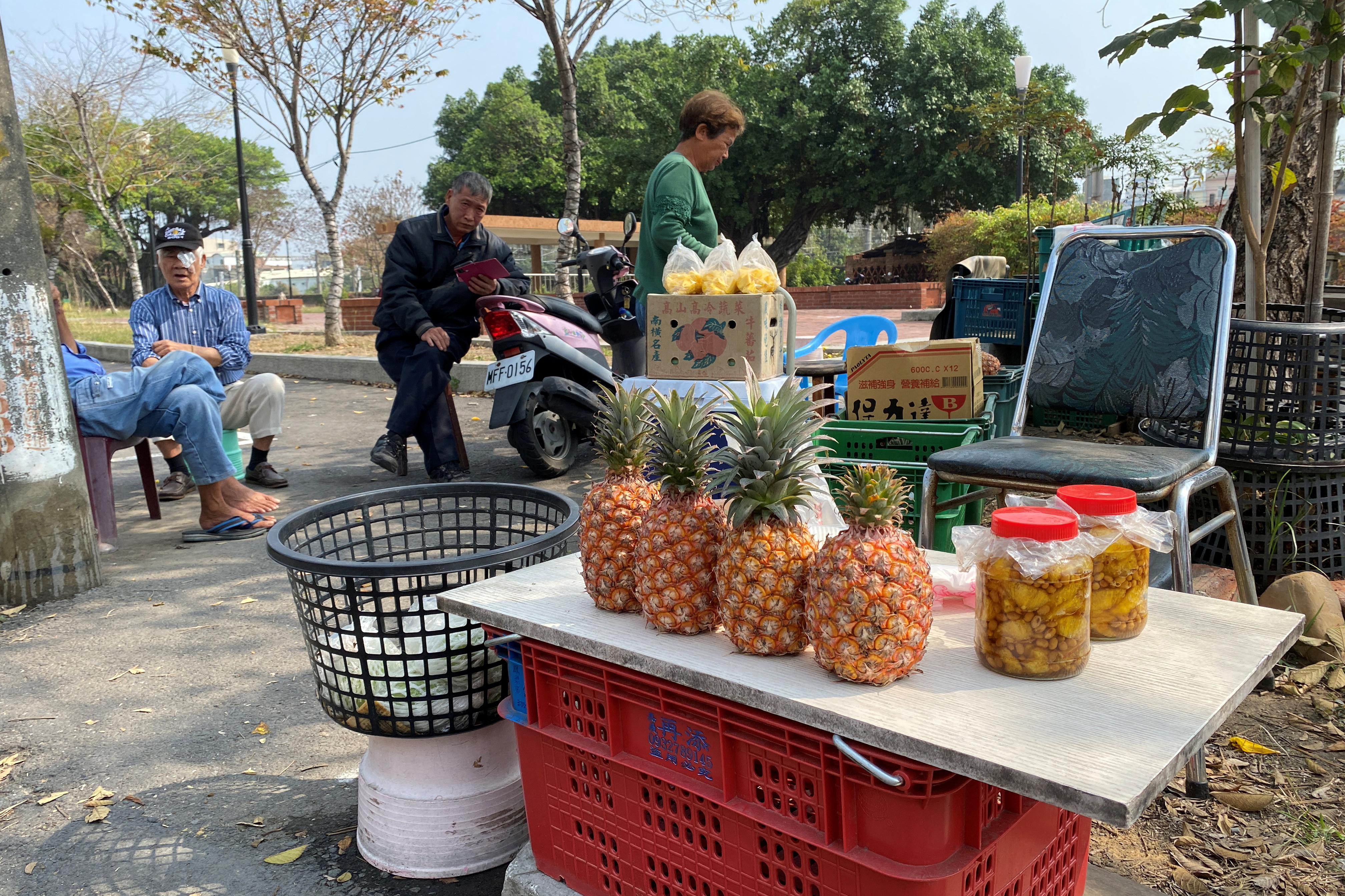 Farmers sell pineapples at a stall by the road in Kaohsiung