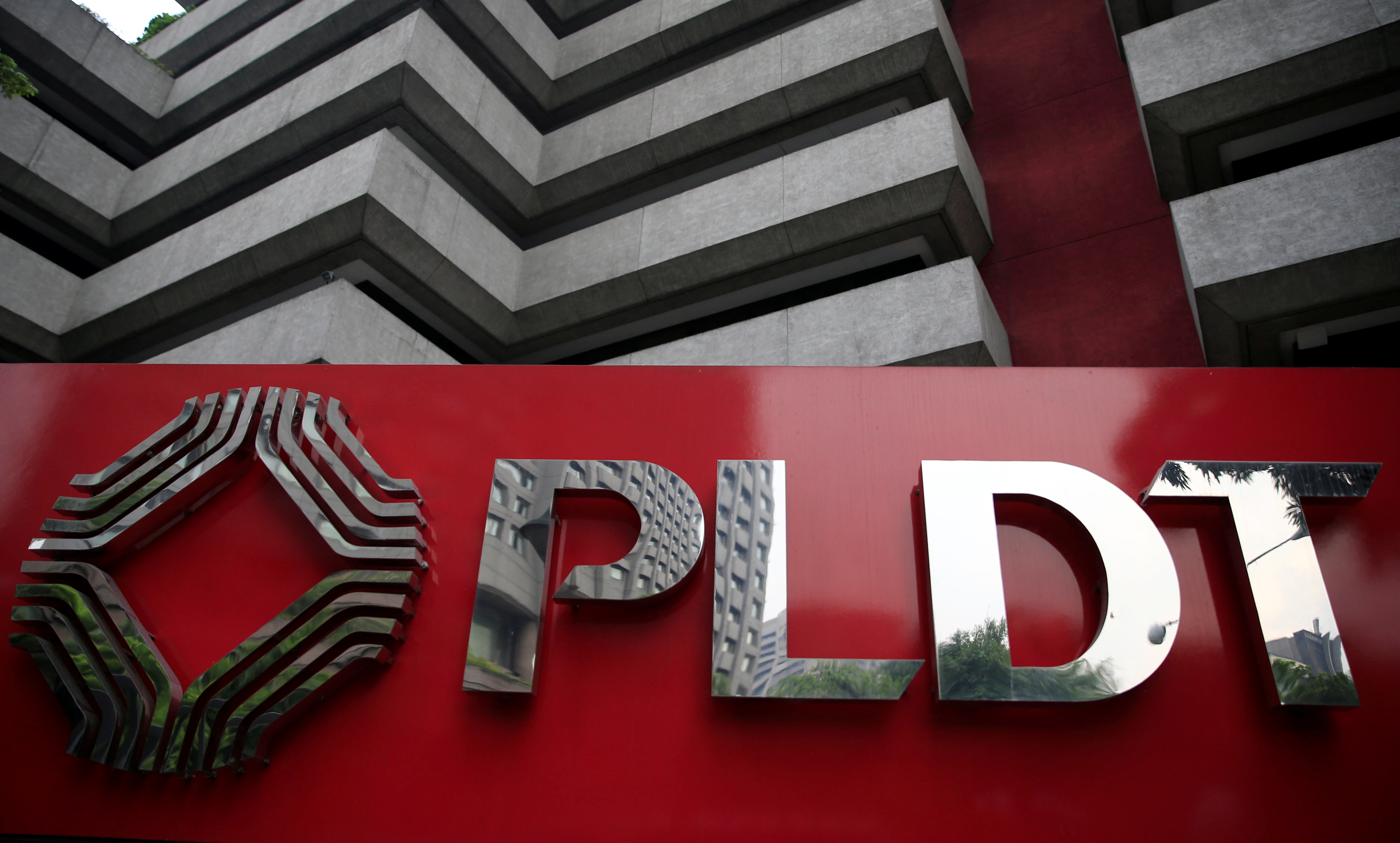 A logo of Philippine Long Distance Telephone Company (PLDT) is seen in front of their building in Makati city, metro Manila, Philippines
