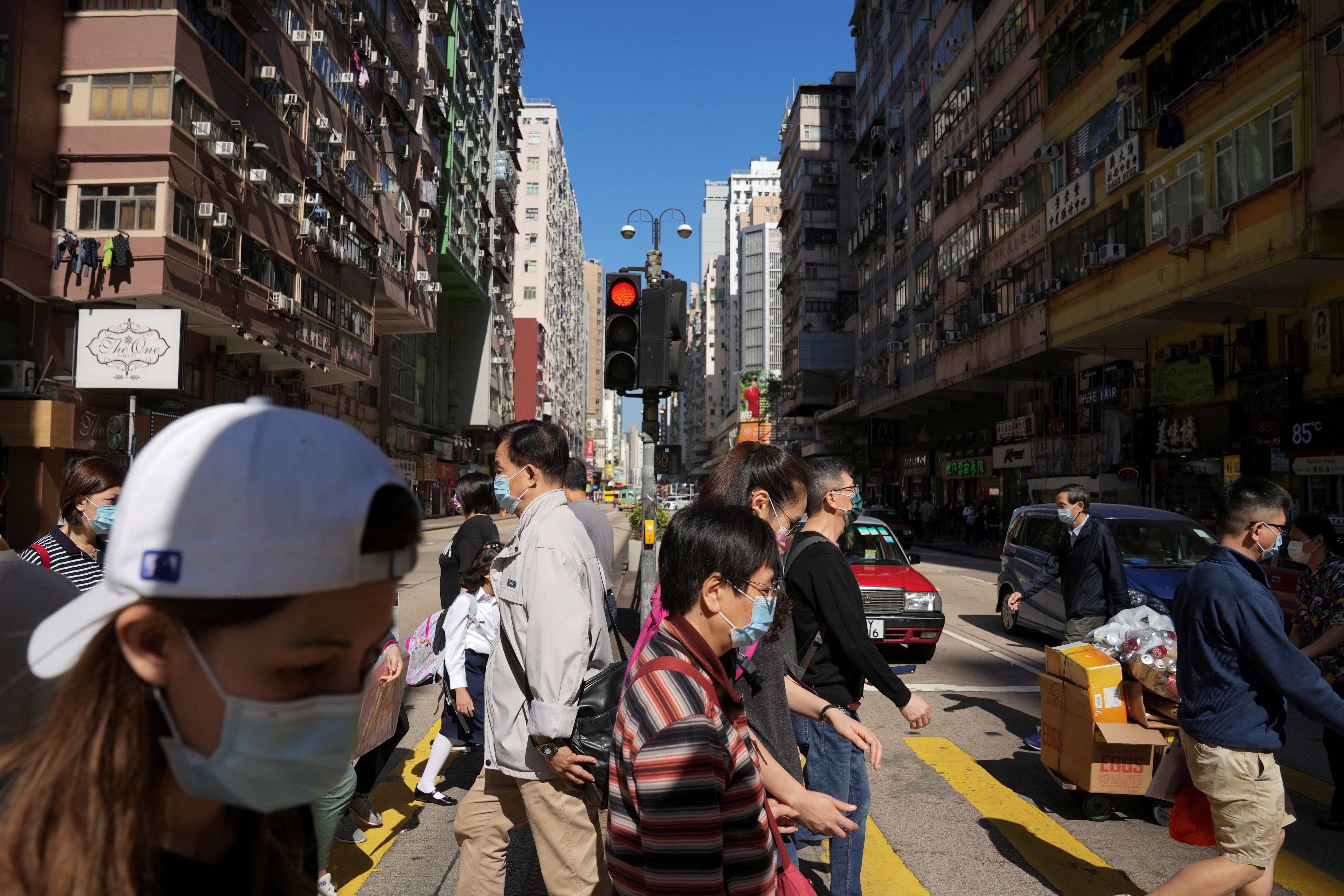 People wearing face masks to prevent the spread of the coronavirus disease (COVID-19), walk on a street in Hong Kong