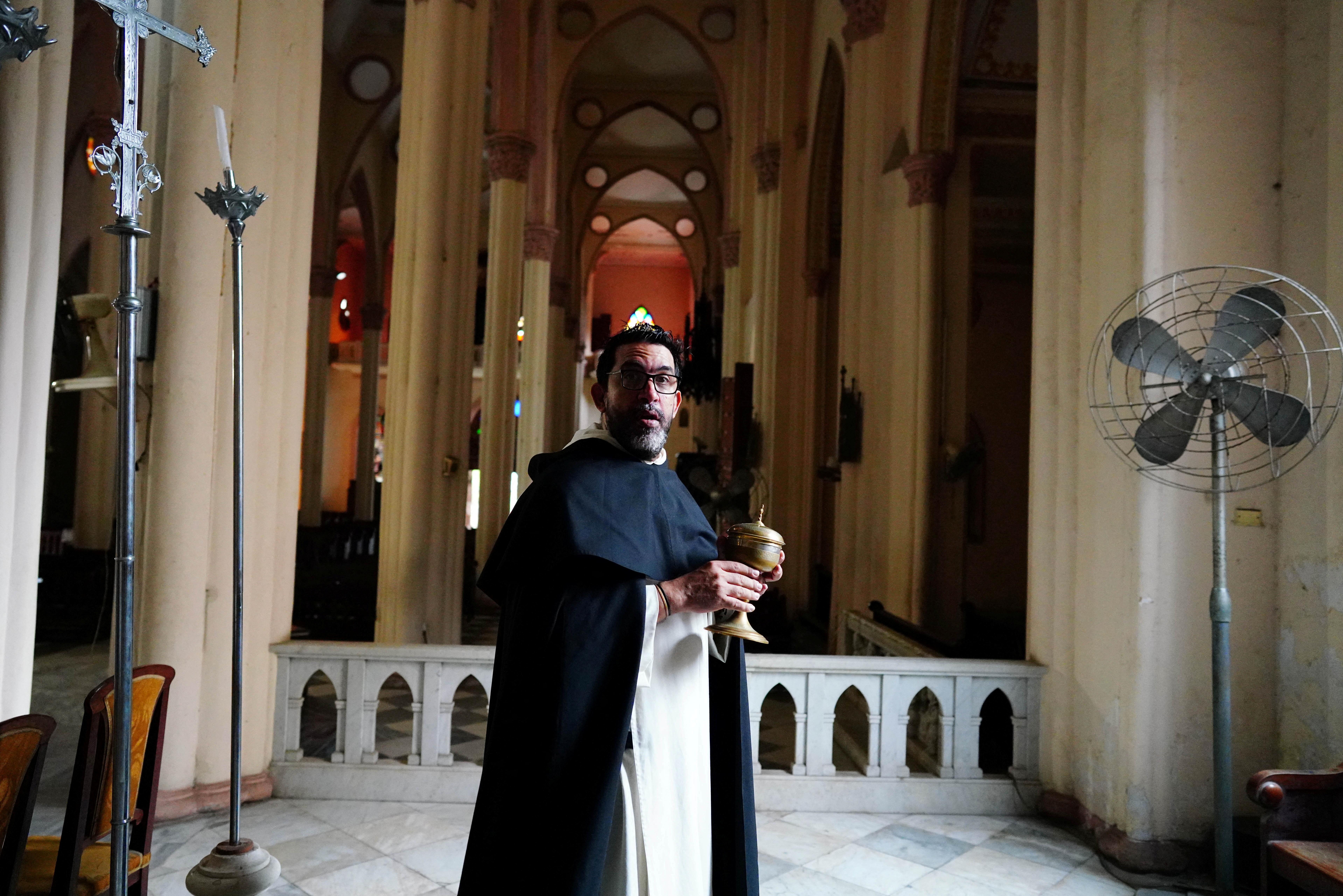 Priest Lester Zayas prepares the church for the Holy Week celebrations in Havana