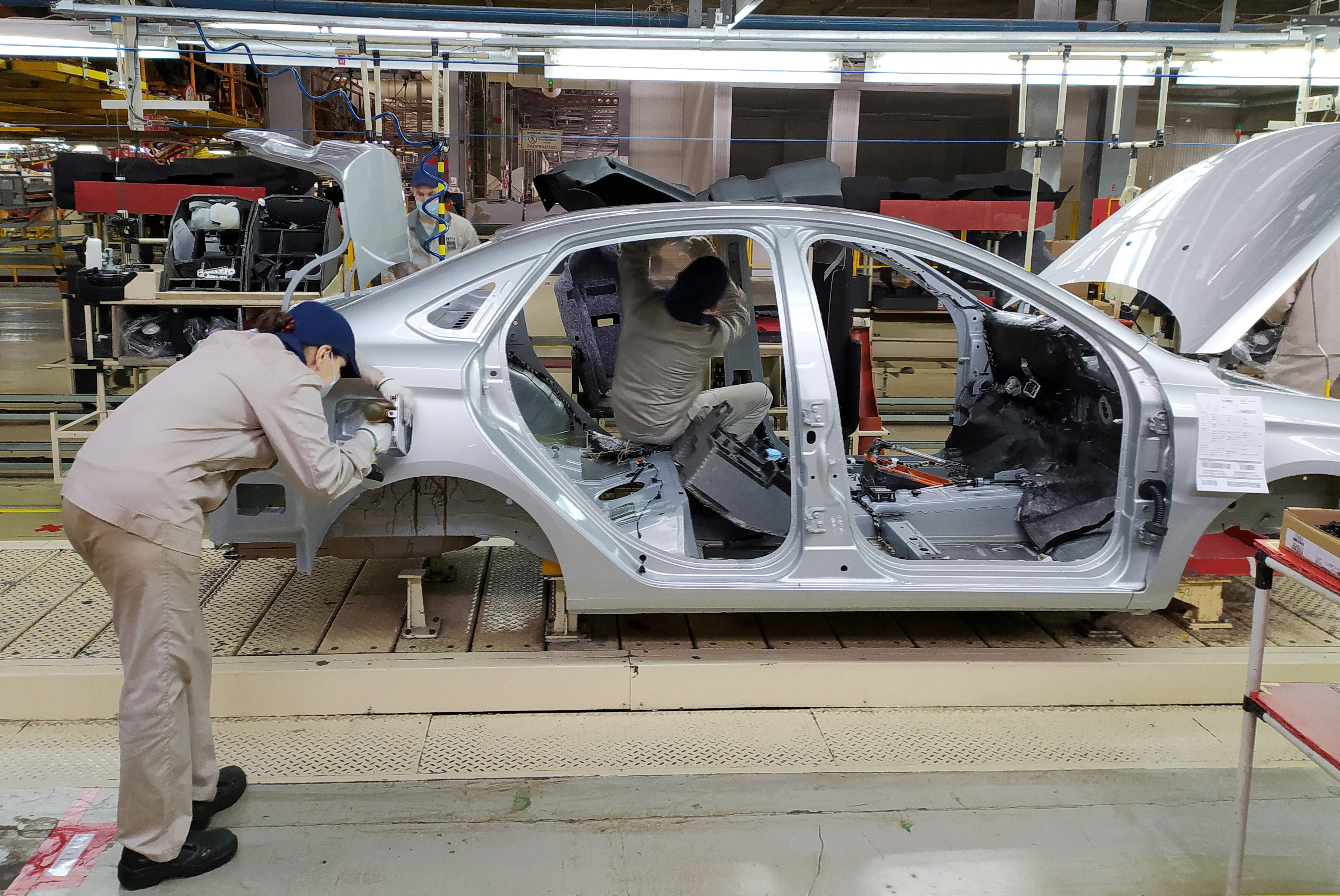 Employees work at the assembly line of the LADA Izhevsk automobile plant in Izhevsk