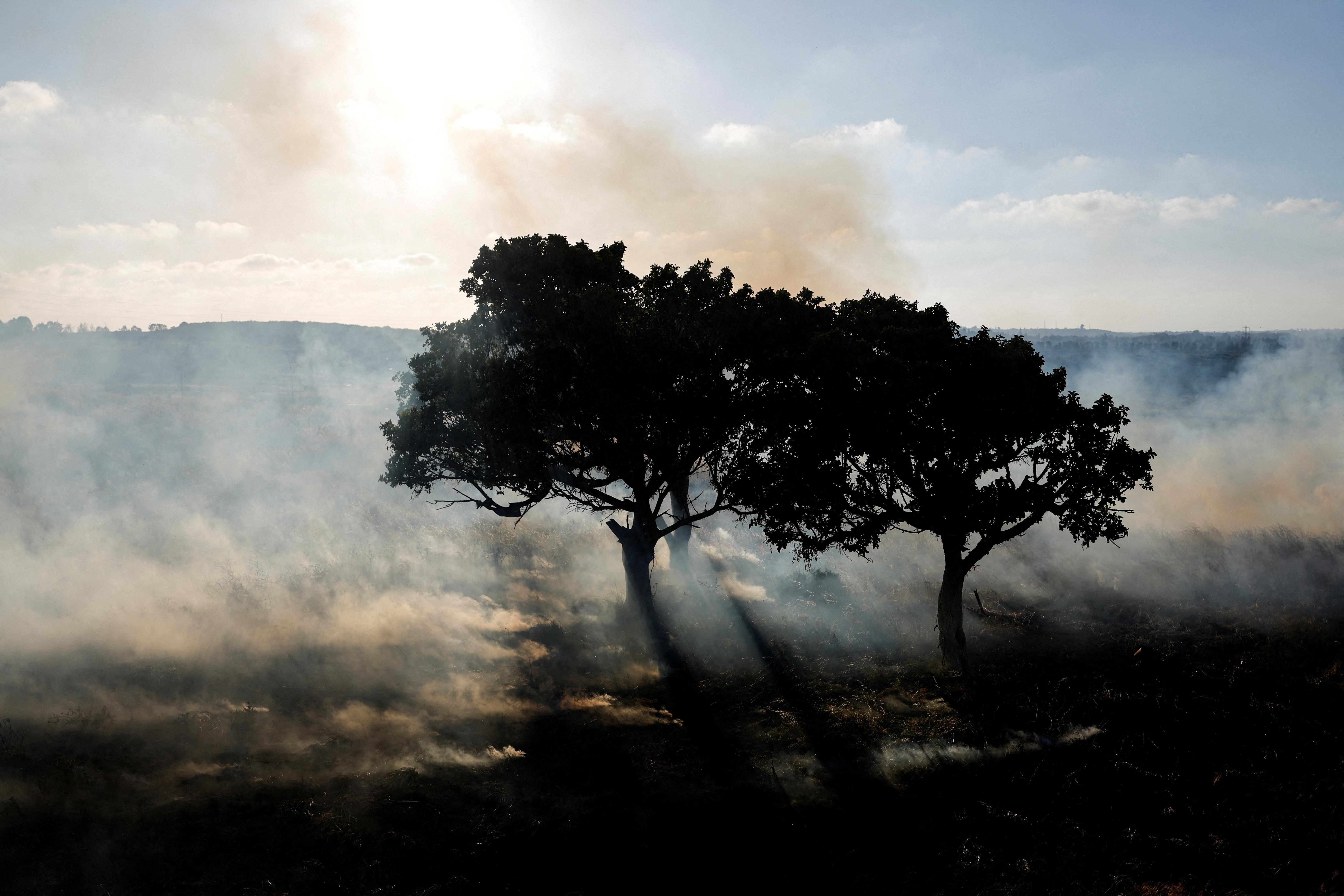 A field burns after a rocket, launched from Gaza, landed in Sderot