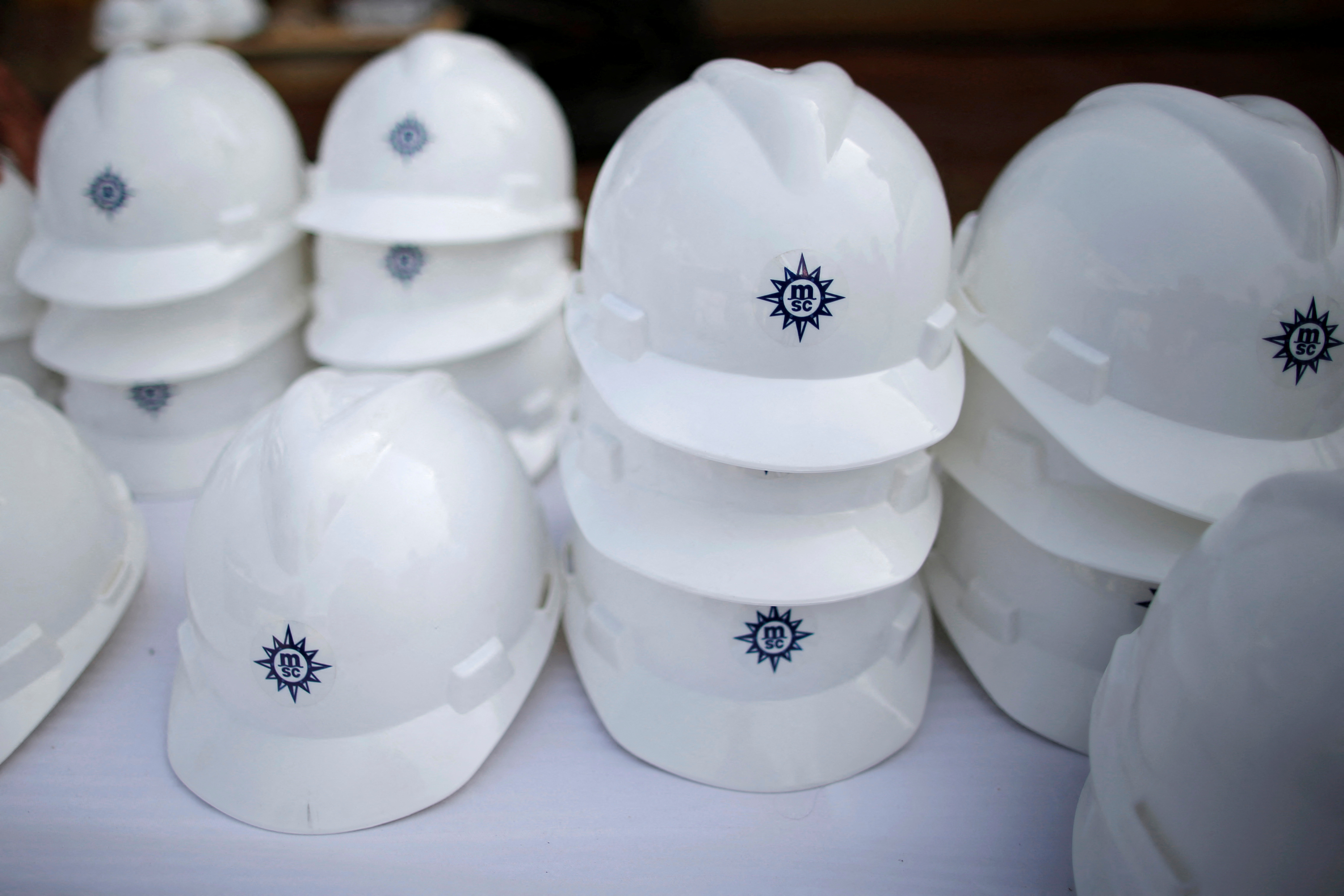 The MSC logo is pictured on working helmet during a press visit of the MSC Meraviglia class ship at the STX Les Chantiers de l'Atlantique shipyard site in Saint-Nazaire