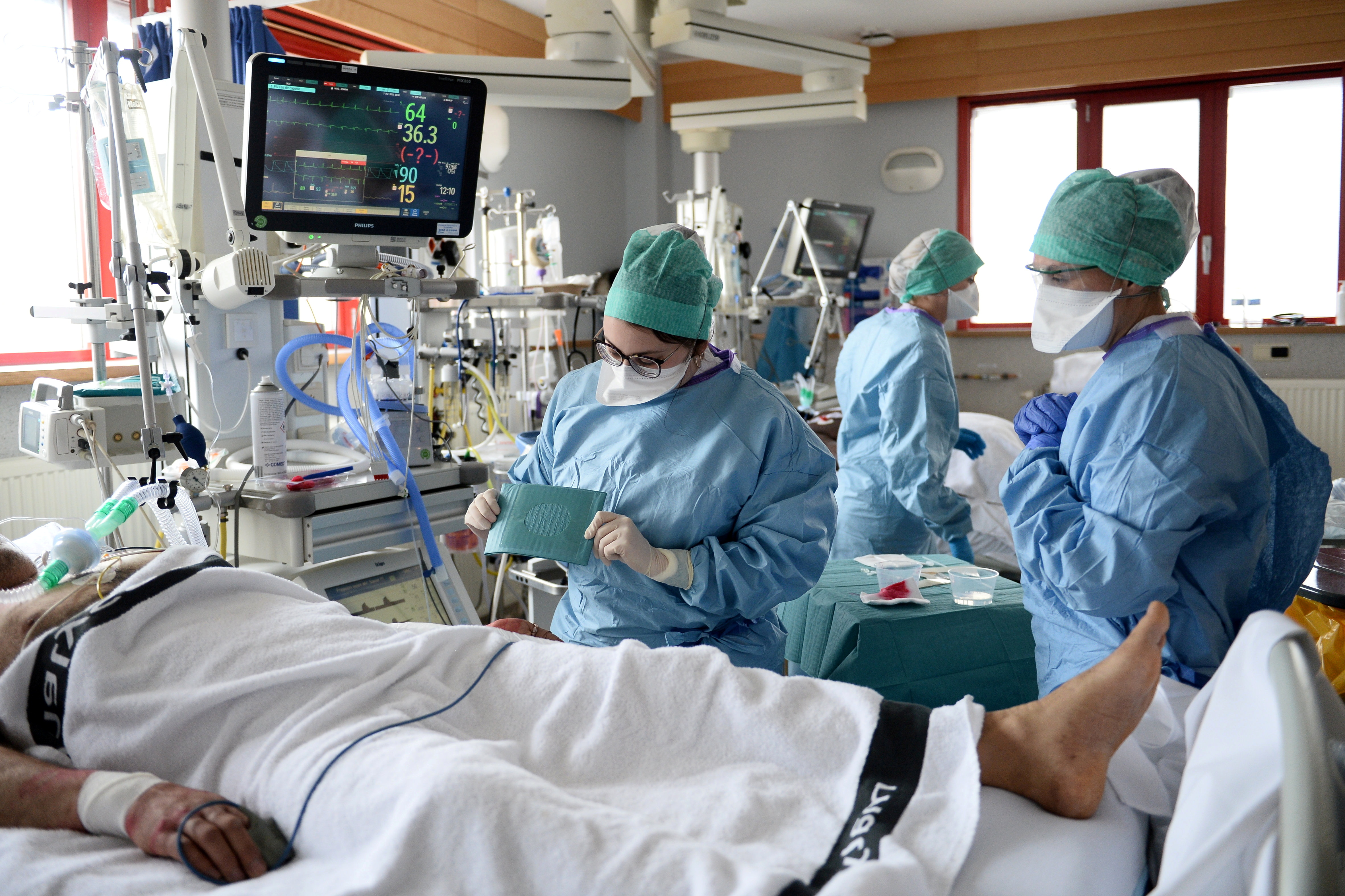 Medical workers work in the Intensive Care Unit (ICU) where patients suffering from the coronavirus disease (COVID-19) are treated at the Saint-Pierre clinic in Ottignies, Belgium