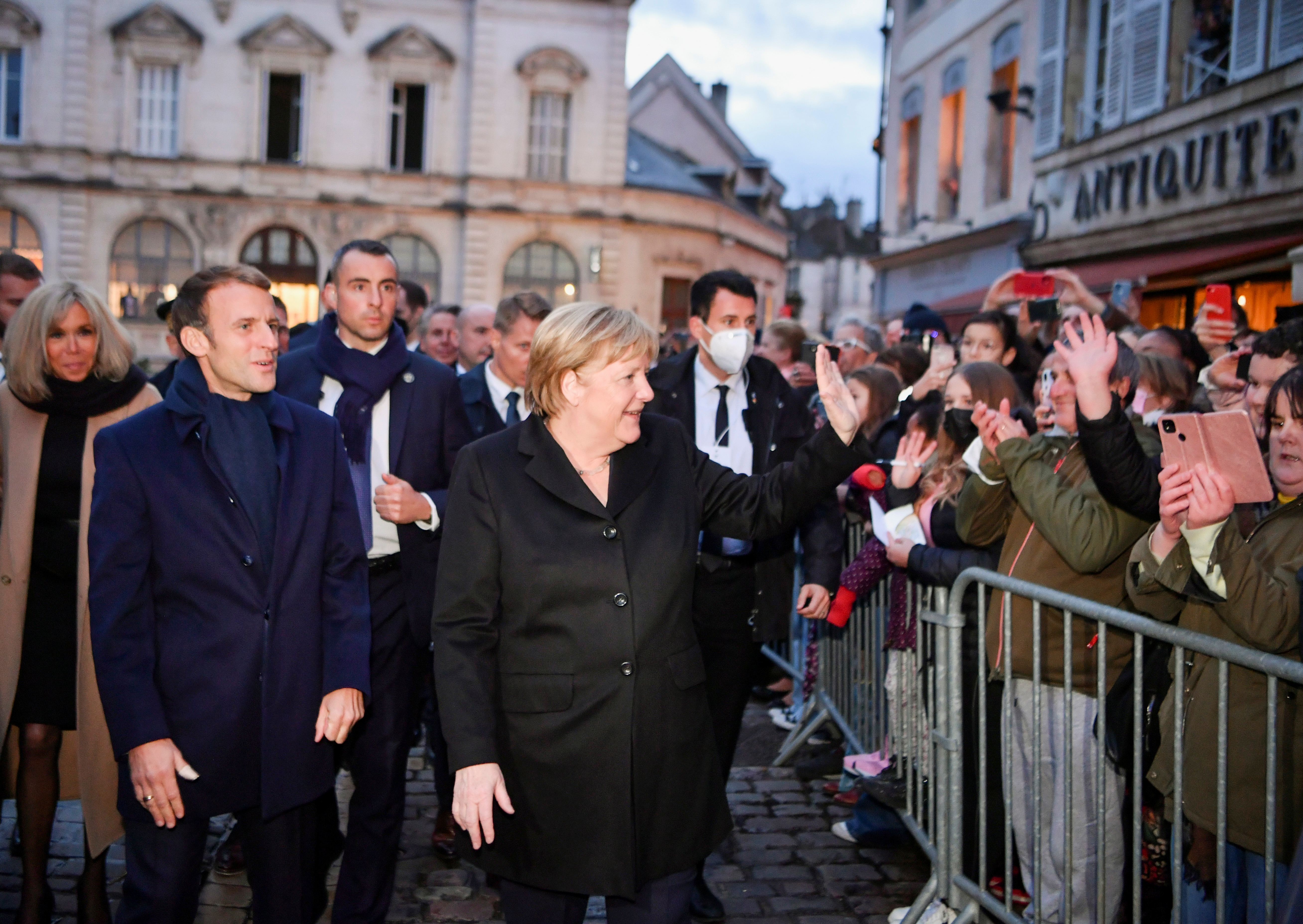 France's President Emmanuel Macron, flanked by his wife Brigitte Macron, arrives for talks with outgoing German Chancellor Angela Merkel, in Beaune, France, November 3, 2021. Philippe Desmazes/Pool via REUTERS