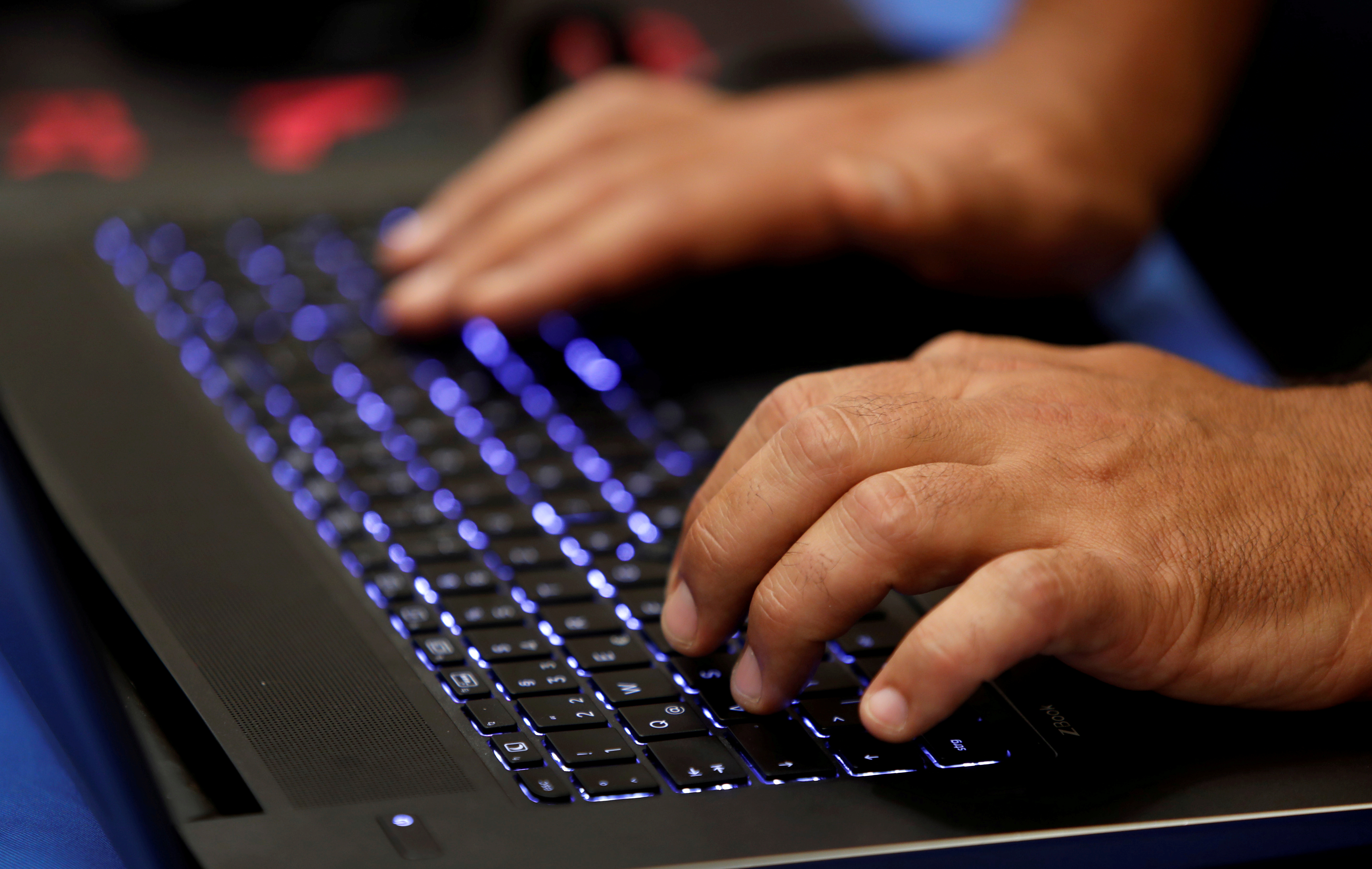 A man types into a keyboard during the Def Con hacker convention in Las Vegas