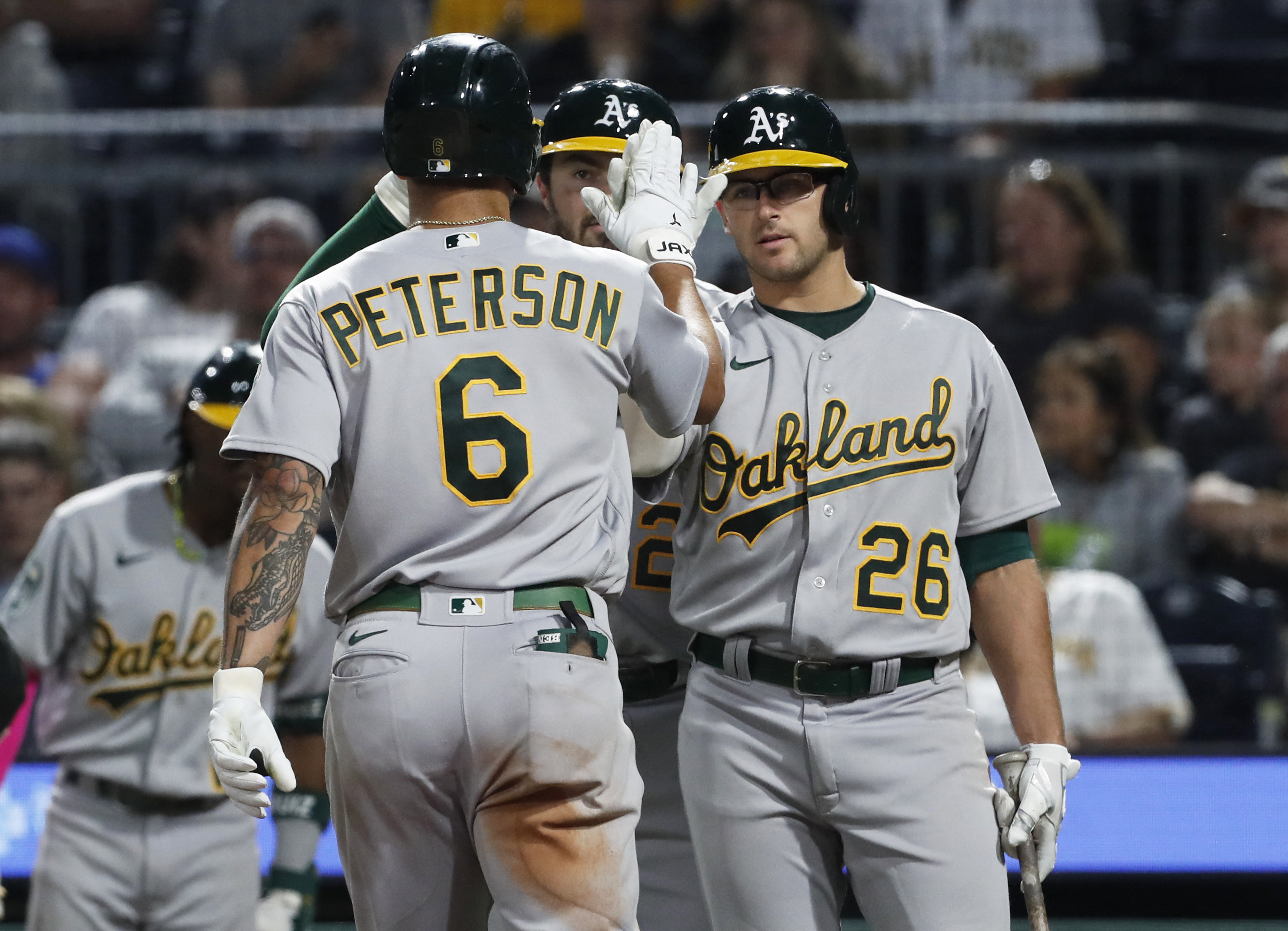 A's sock four homers, batter Pirates to end skid