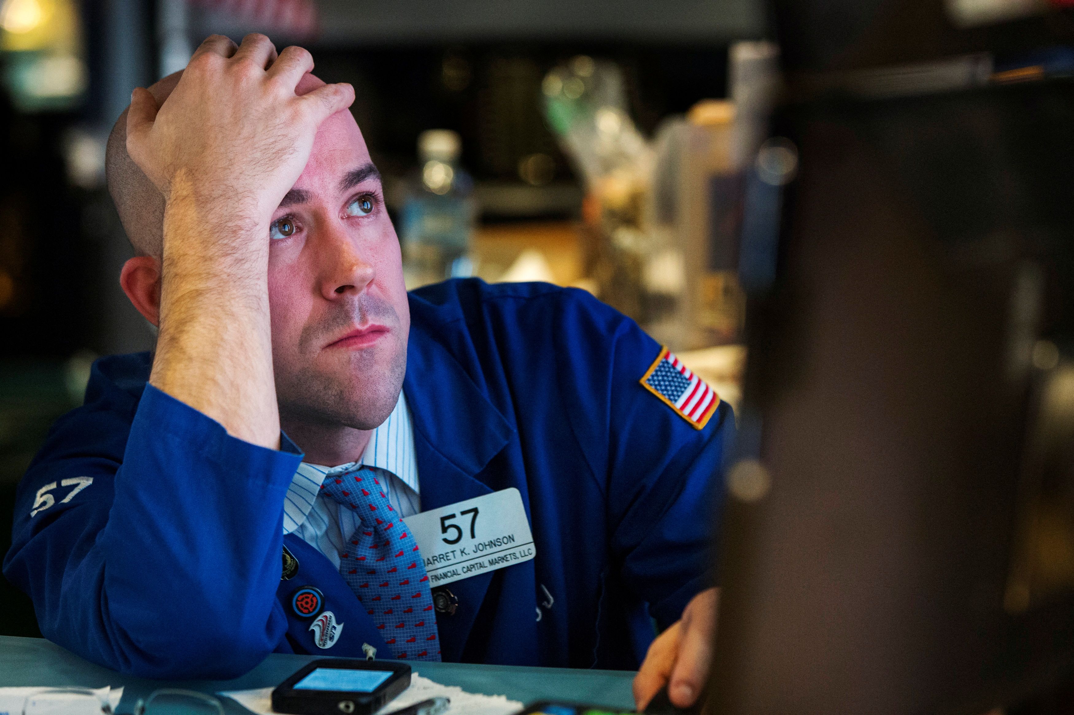 A trader watches the screen at his terminal on the floor of the New York Stock Exchange in New York