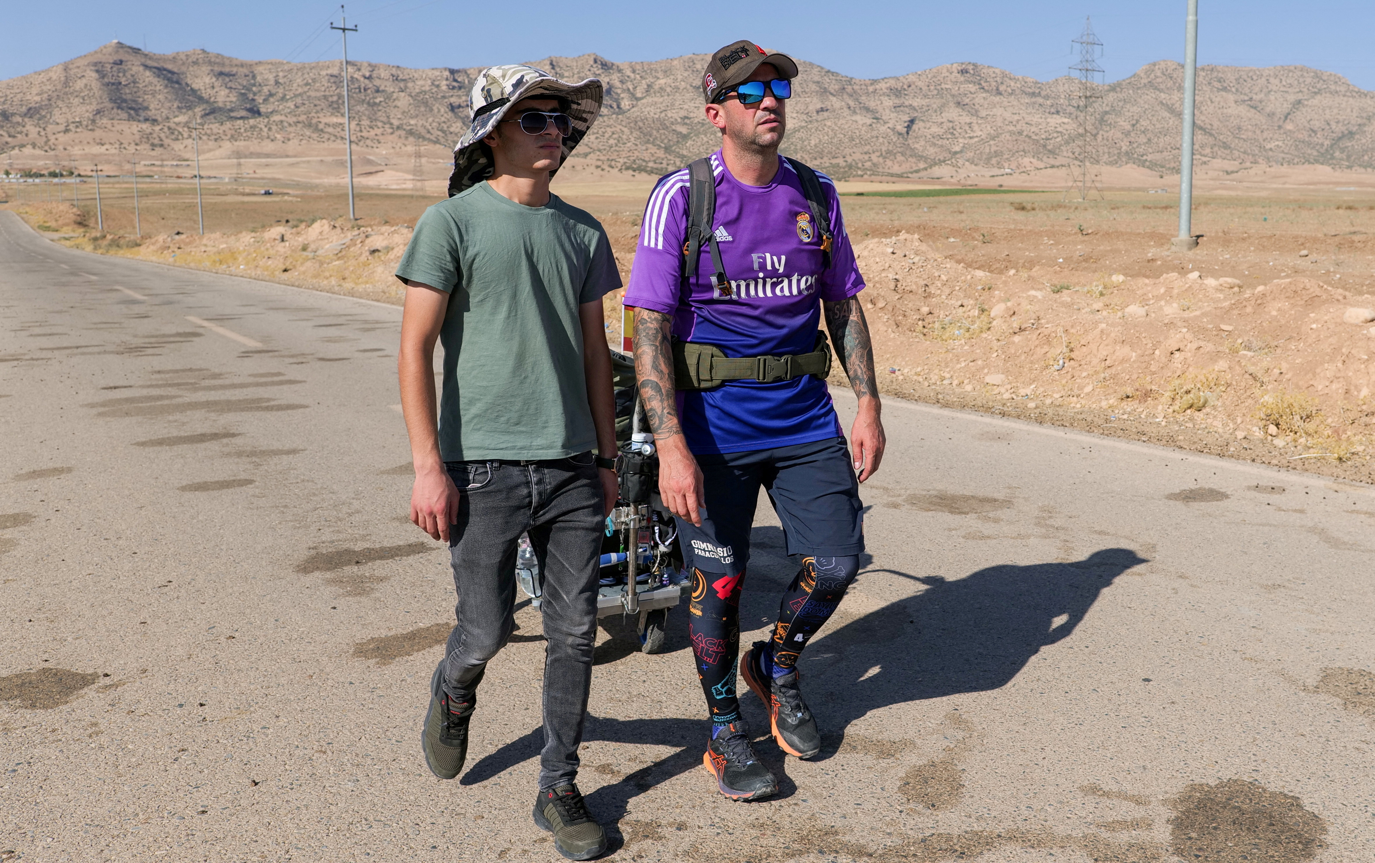 Spanish man, Santiago Sanchez, walks in Iraq's Kurdistan region towards Qatar, where he aims to attend the 2022 World Cup, near Zakho
