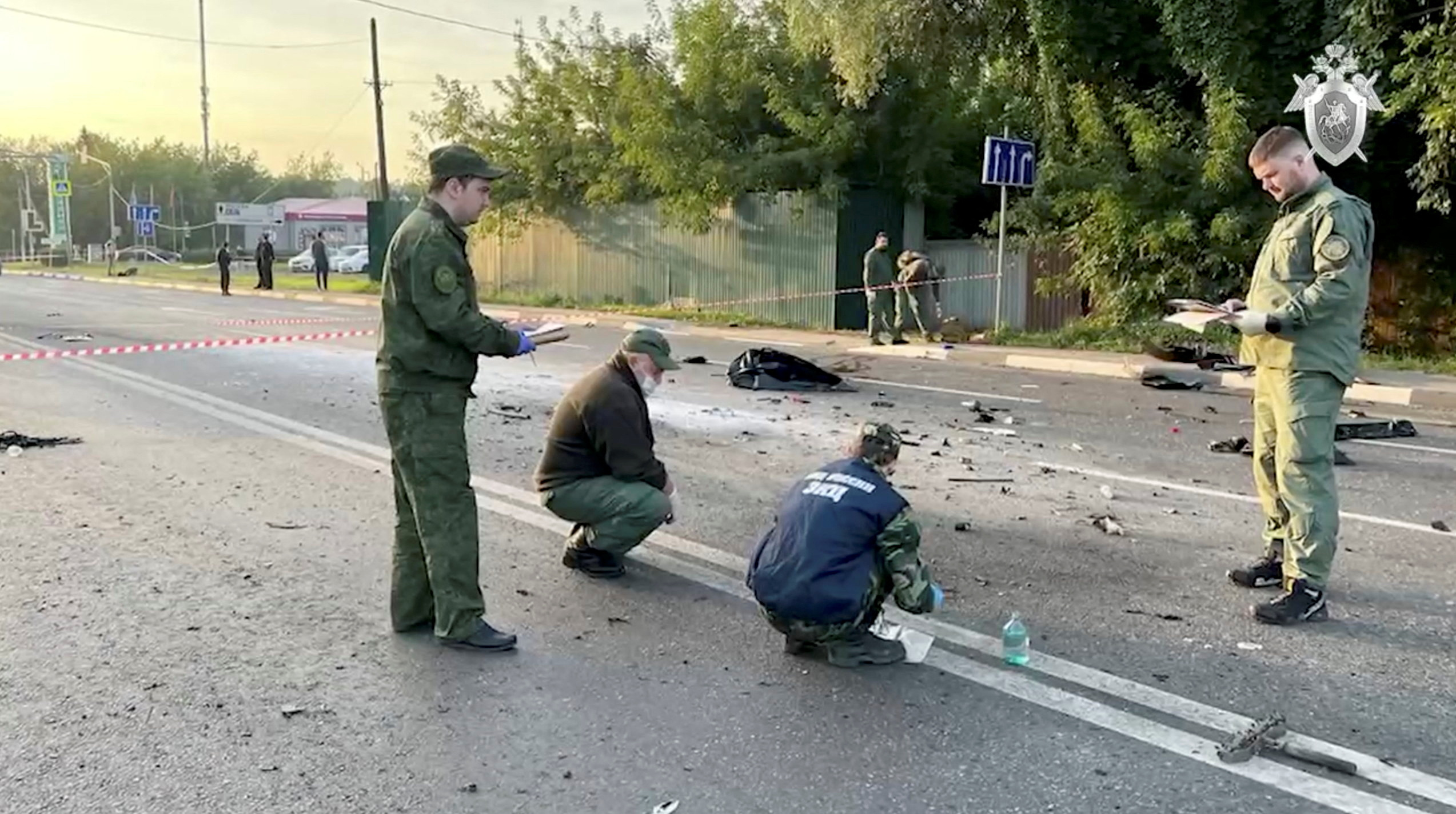 Investigators work at the site of a suspected car bomb attack that killed Darya Dugina in Moscow region