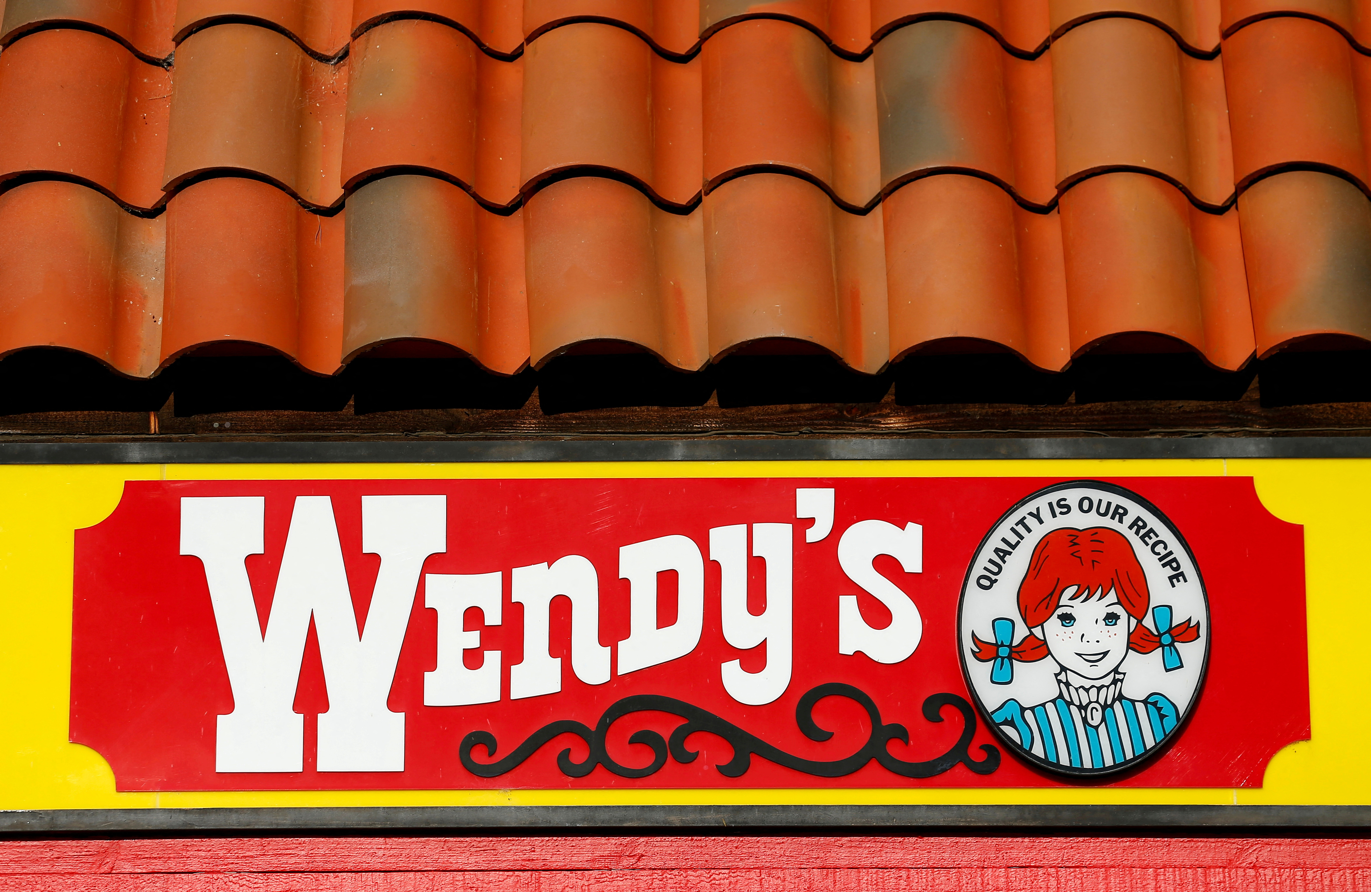 A Wendy's sign and logo are shown at one of the company's restaurant in Encinitas, California