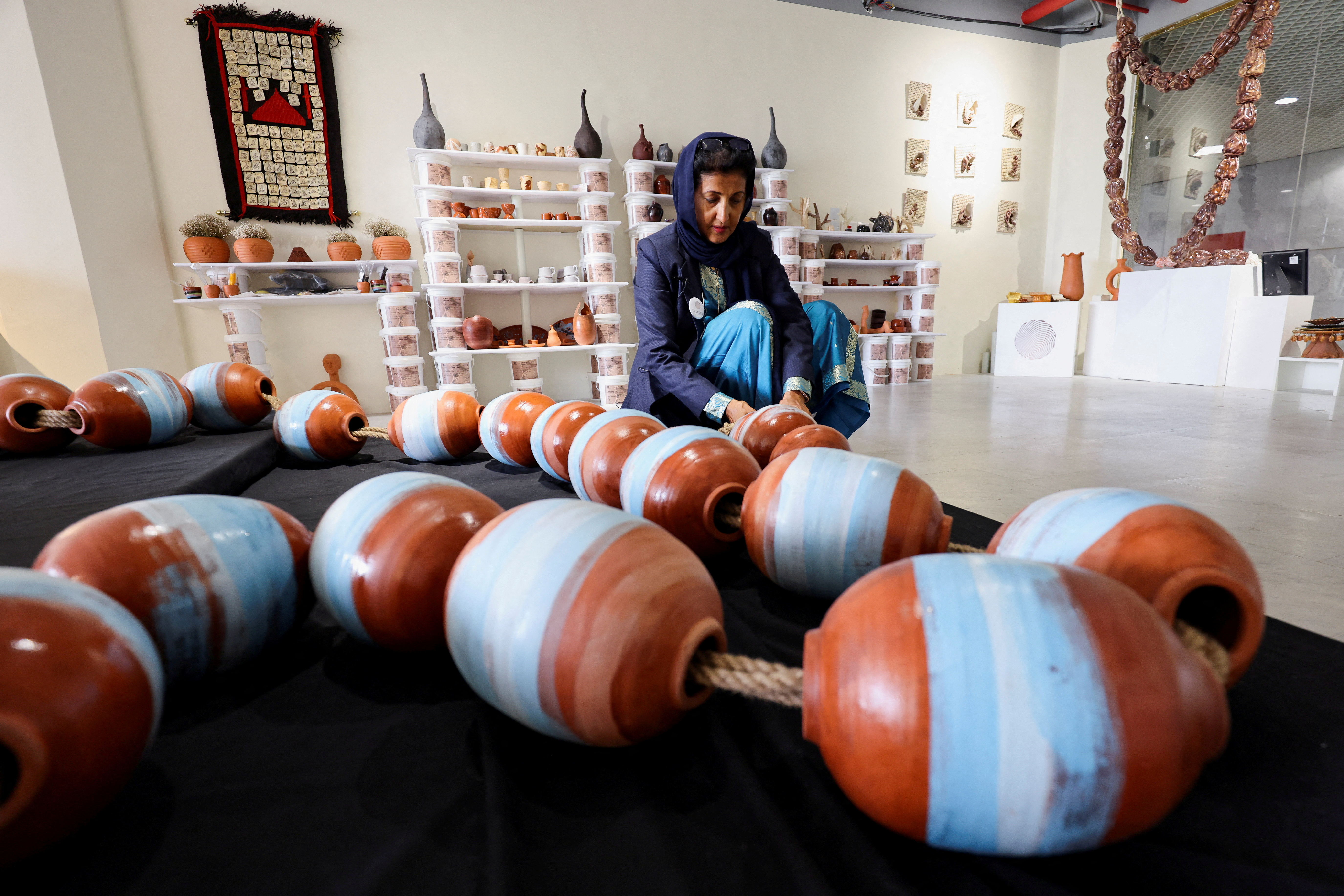 Awatif Al-Keneibit, a Saudi artist, shows her art in her studio, in Riyadh