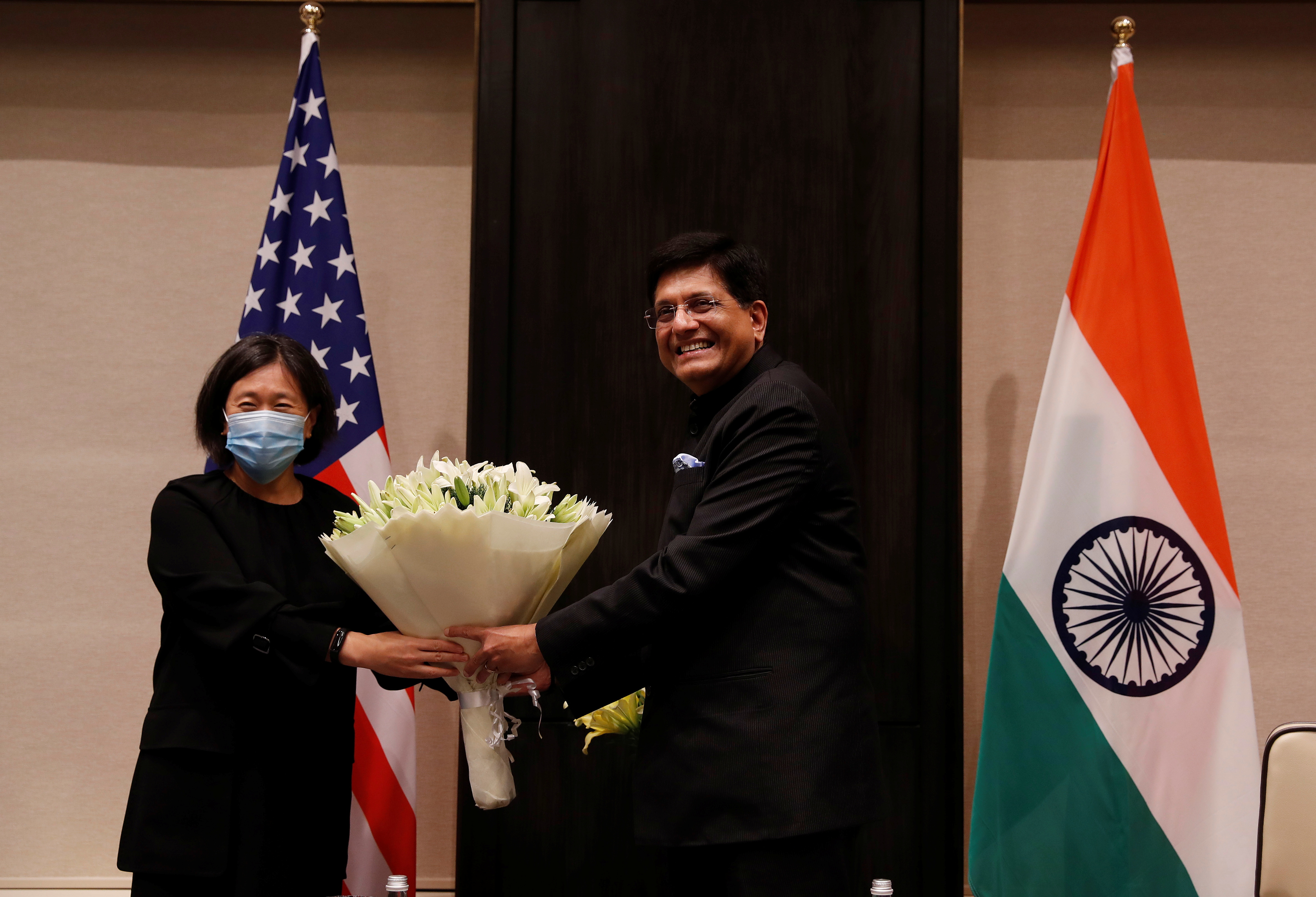 India's Minister of Commerce and Industry, Piyush Goyal, presents a bouquet to U.S. Trade Representative Katherine Tai before start of their meeting in New Delhi