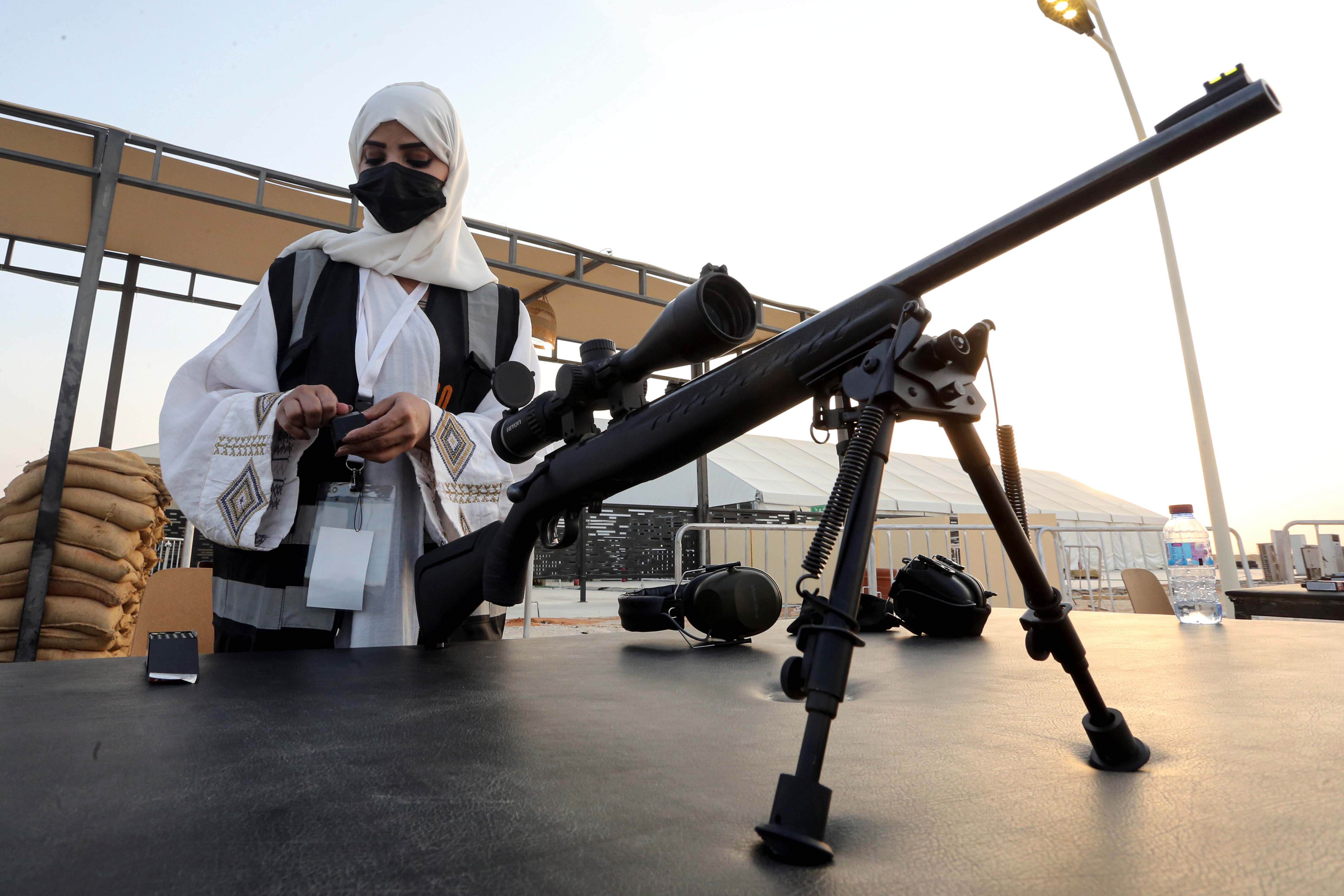 Saudi female firearm trainer, Mona Al Khurais, loads bullets in a gun-magazine prior to her long-range rifle training at the Top-Gun shooting range in Riyadh, Saudi Arabia, October 28, 2021. REUTERS/Ahmed Yosri