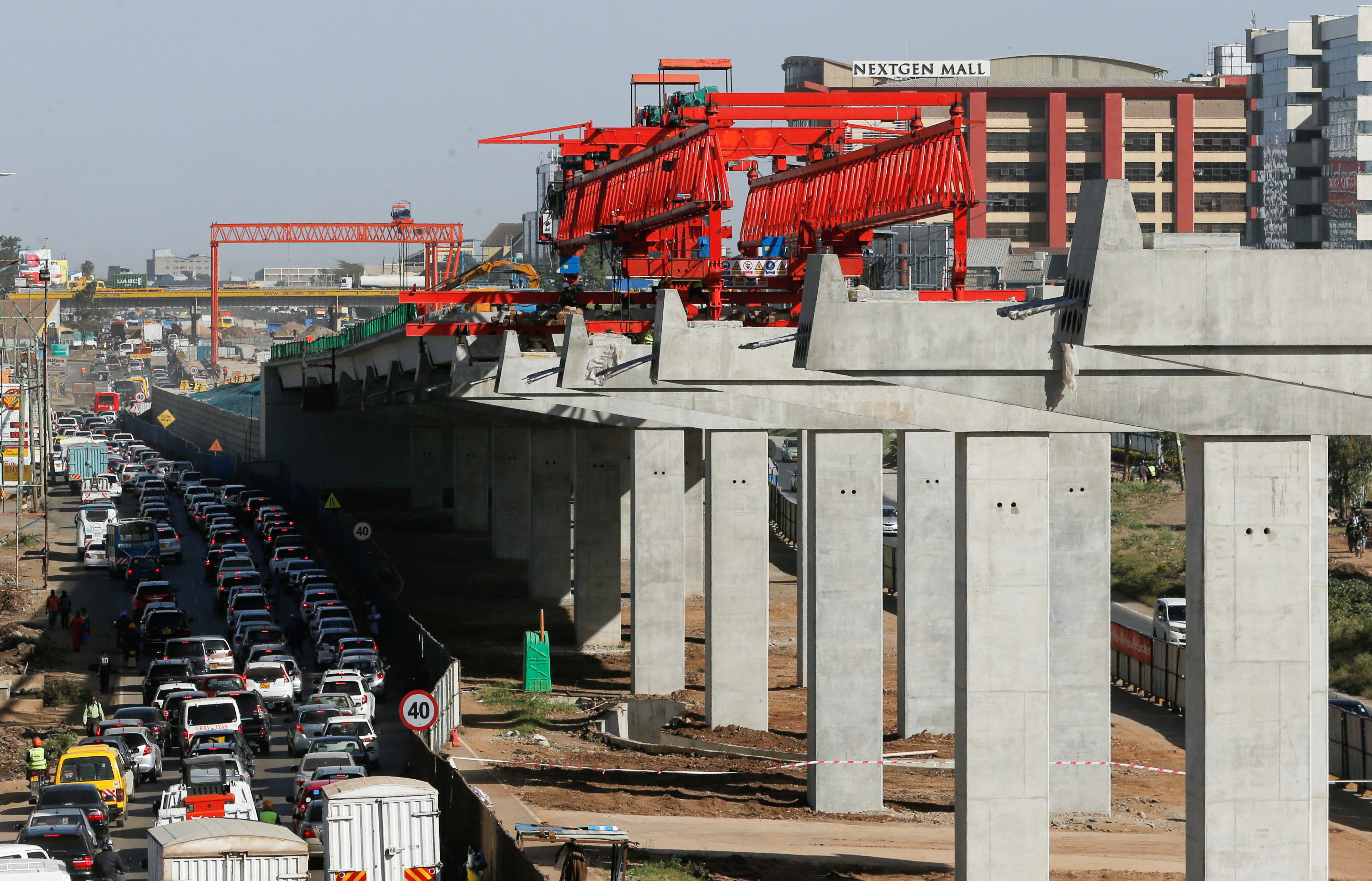Concrete pillars are seen erected as motorists drive on the controlled diversion during the construction of the Nairobi Expressway in Nairobi