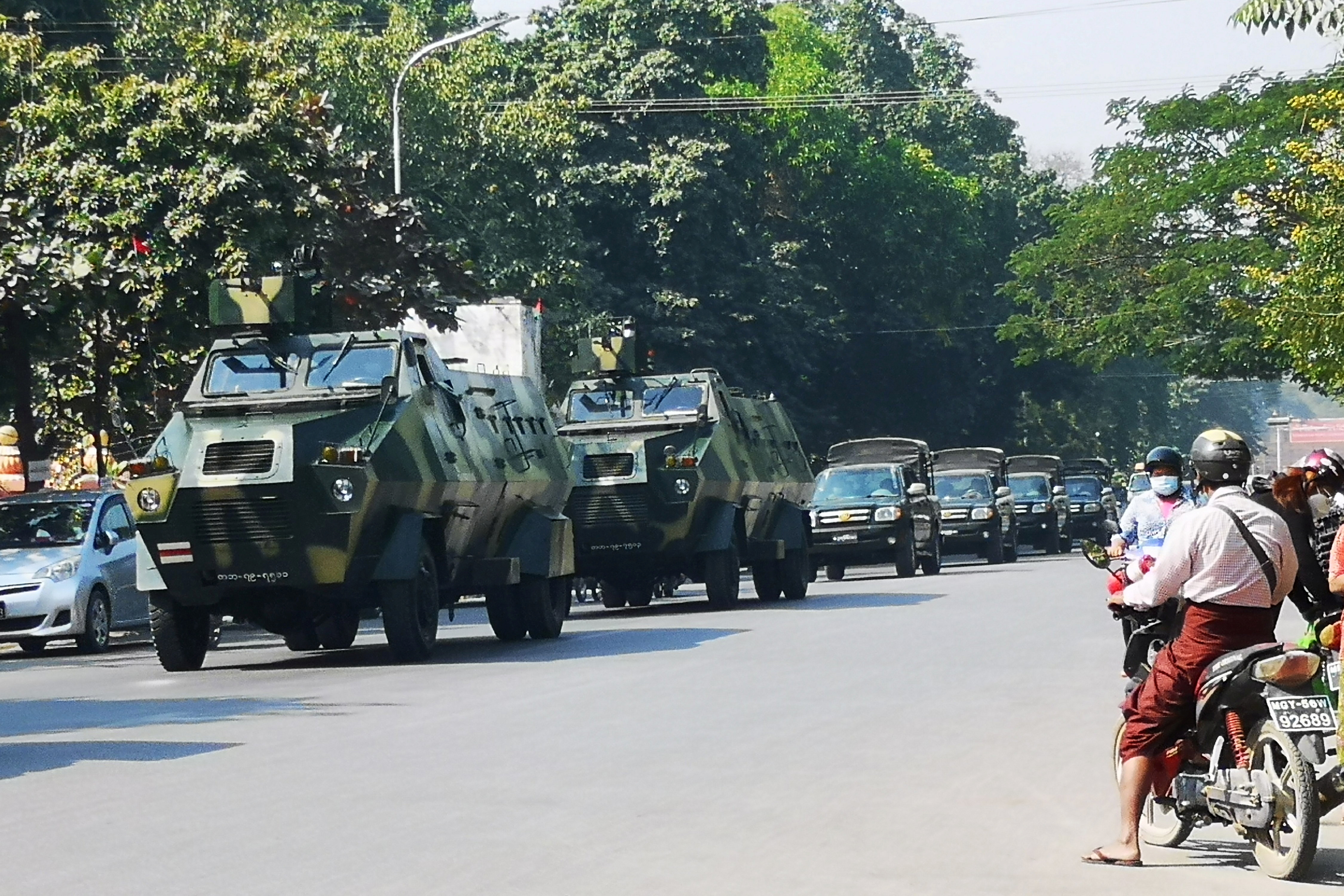 Myanmar Army armored vehicles drive past a street after they seized power in a coup in Mandalay