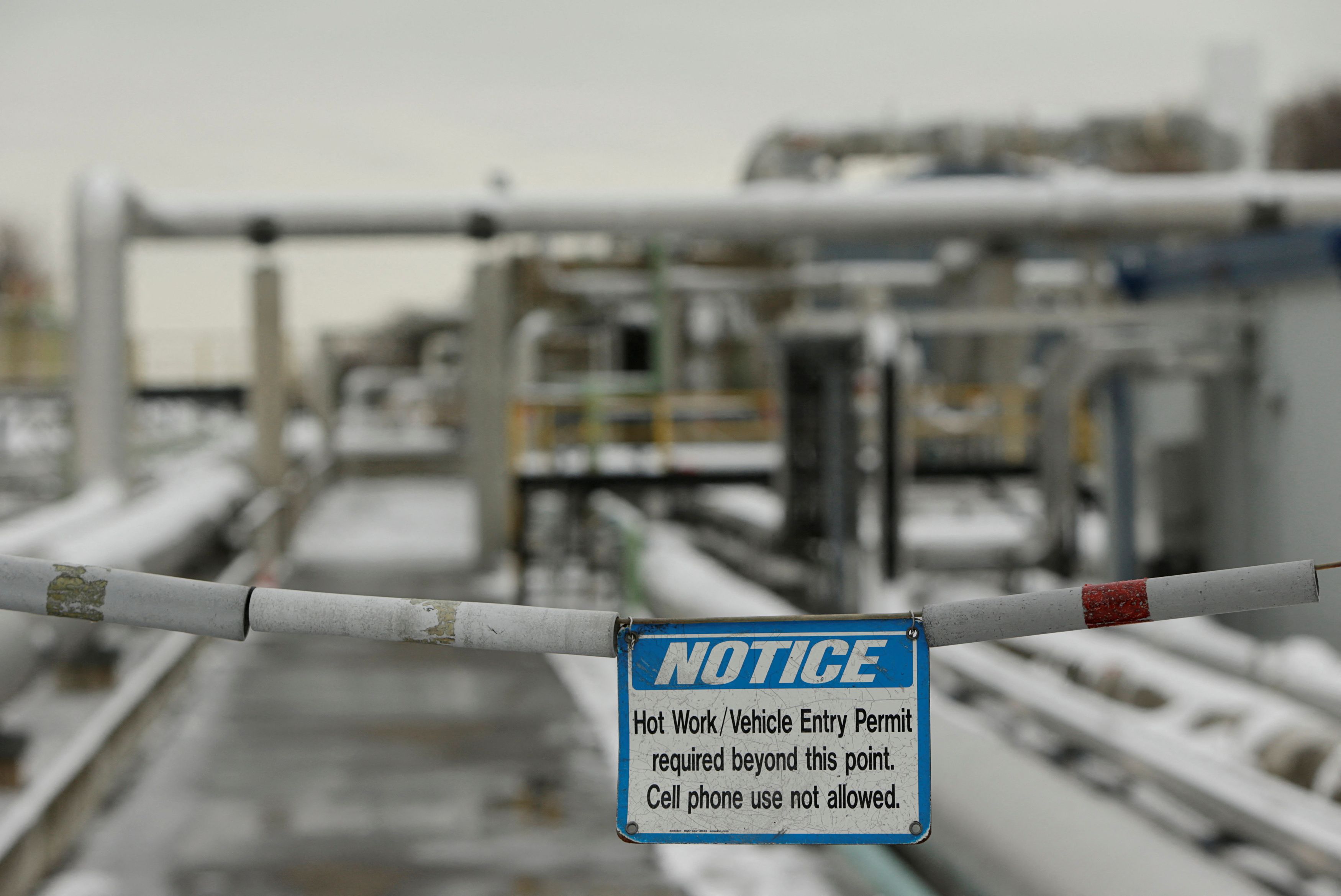 Warning sign is seen with transfer lines at Dominion Cove Point Liquefied Natural Gas terminal in Maryland