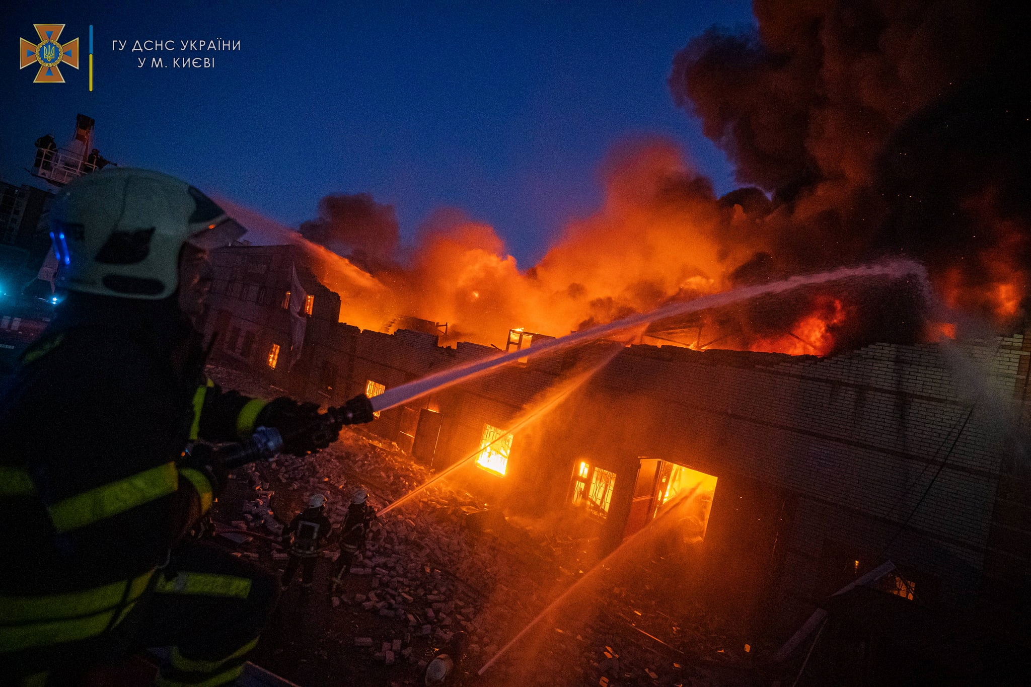 Rescuers work at a site of buildings damaged by a shelling in Kyiv