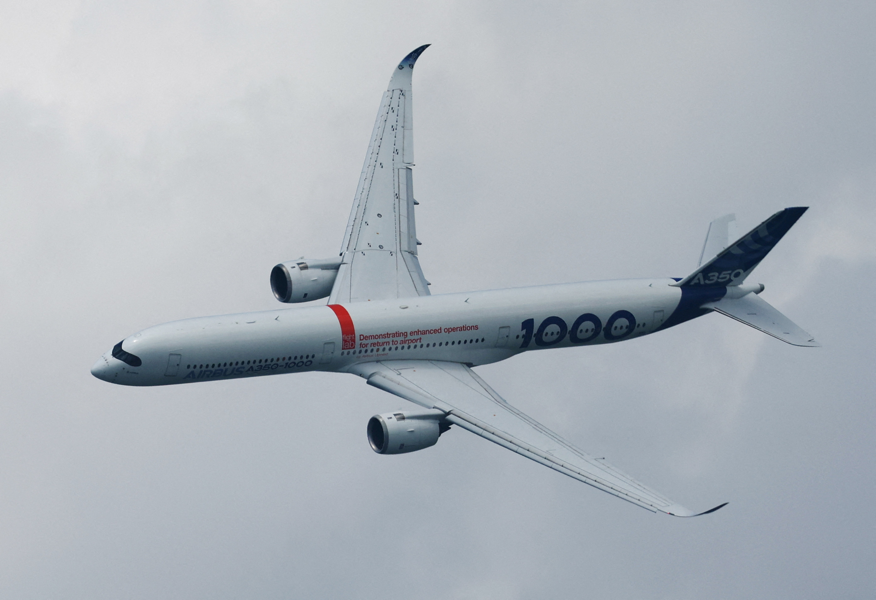 An Airbus A350-1000 flies during an aerial display at the Singapore Airshow at Changi Exhibition Centre