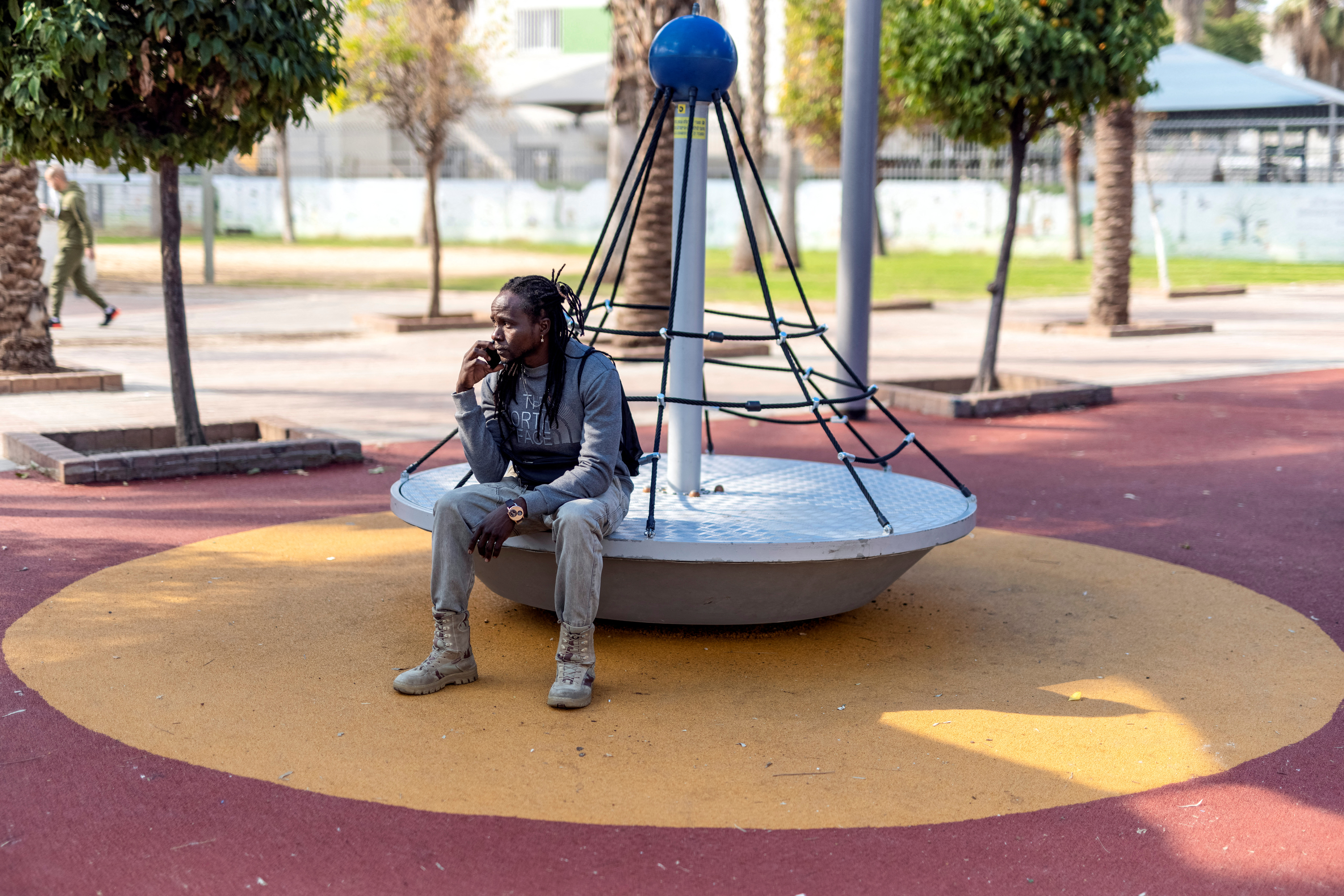 Sabona Hassan, an asylum seeker who fled Darfur, Sudan sits in a park in southern Tel Aviv