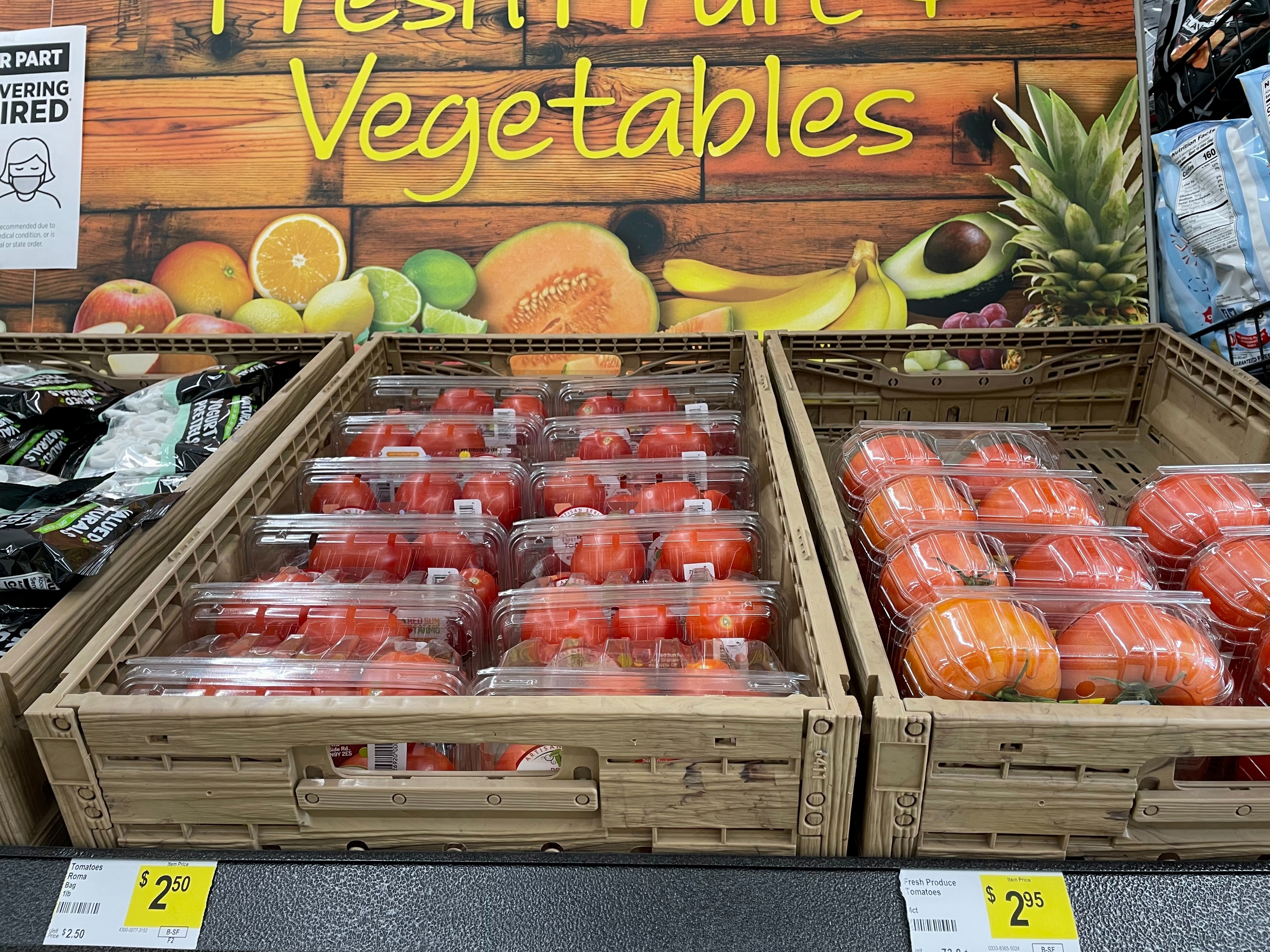 Boxes of tomatoes are seen in a fresh food aisle at a Dollar General store in Norridge