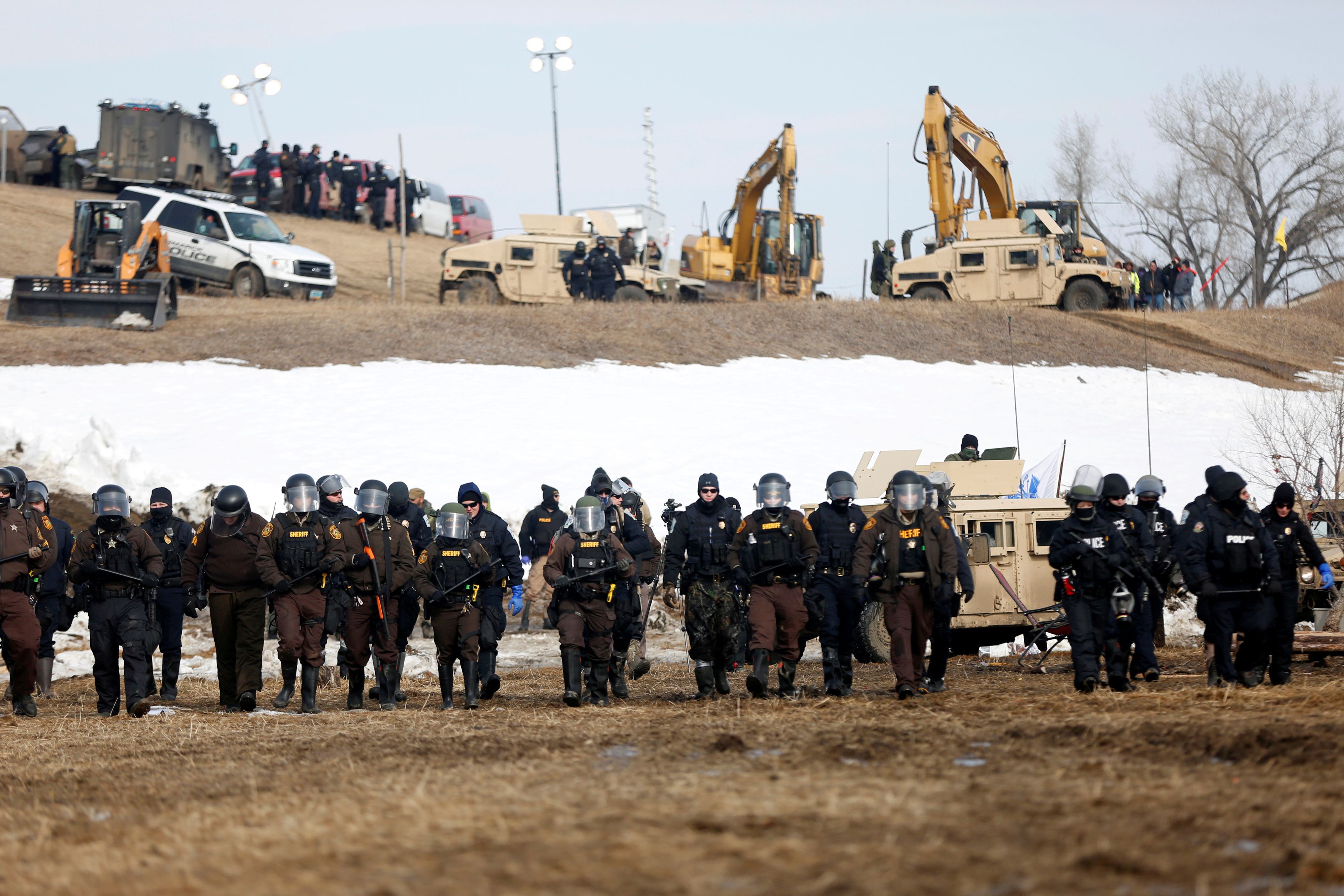 Law enforcement officers advance into the main opposition camp against the Dakota Access oil pipeline near Cannon Ball, North Dakota, U.S., February 23, 2017. REUTERS/Terray Sylvester/File Photo
