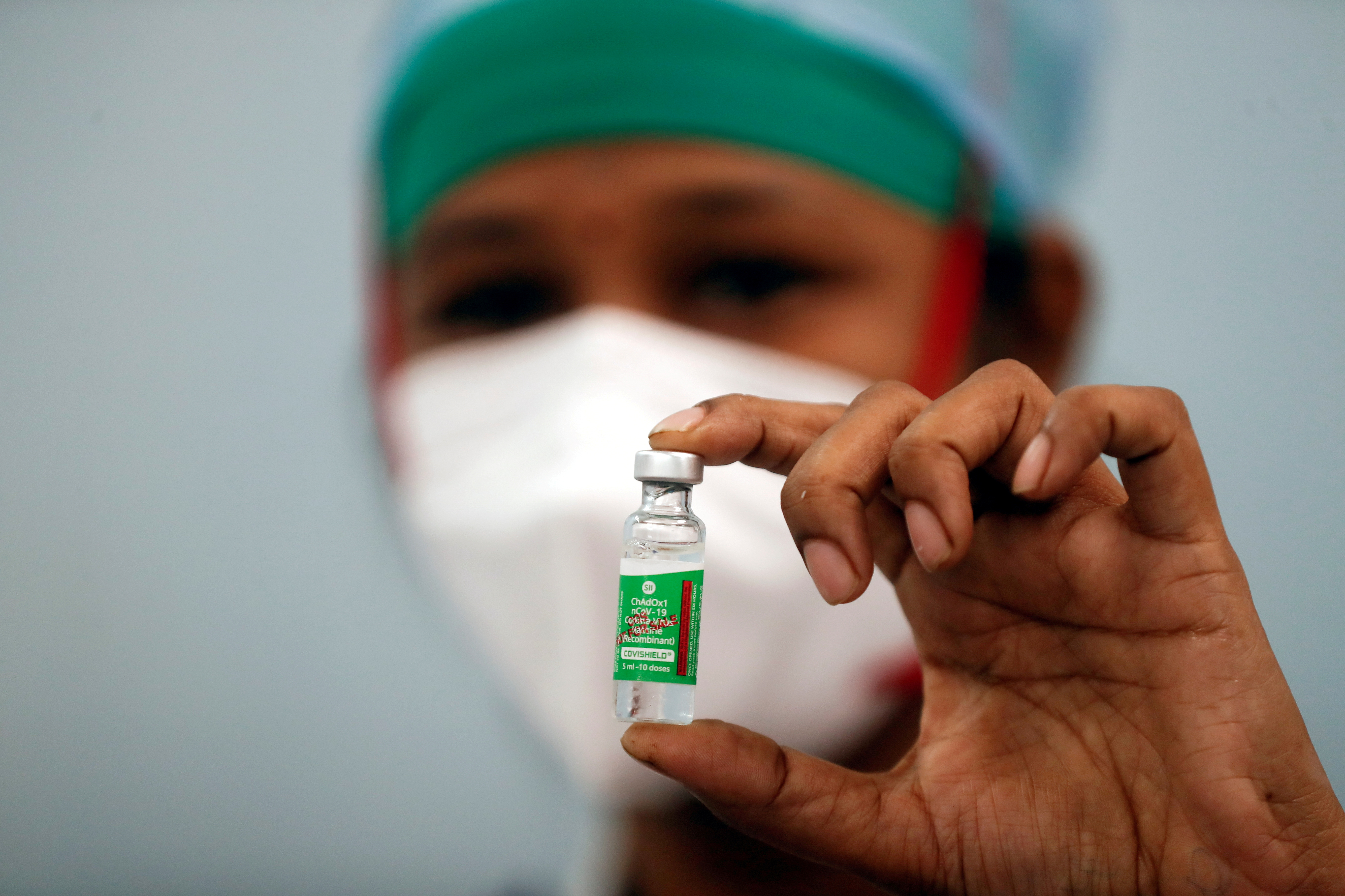 A nurse displays a vial of COVISHIELD, the AstraZeneca COVID-19 vaccine manufactured by Serum Institute of India, in Mumbai