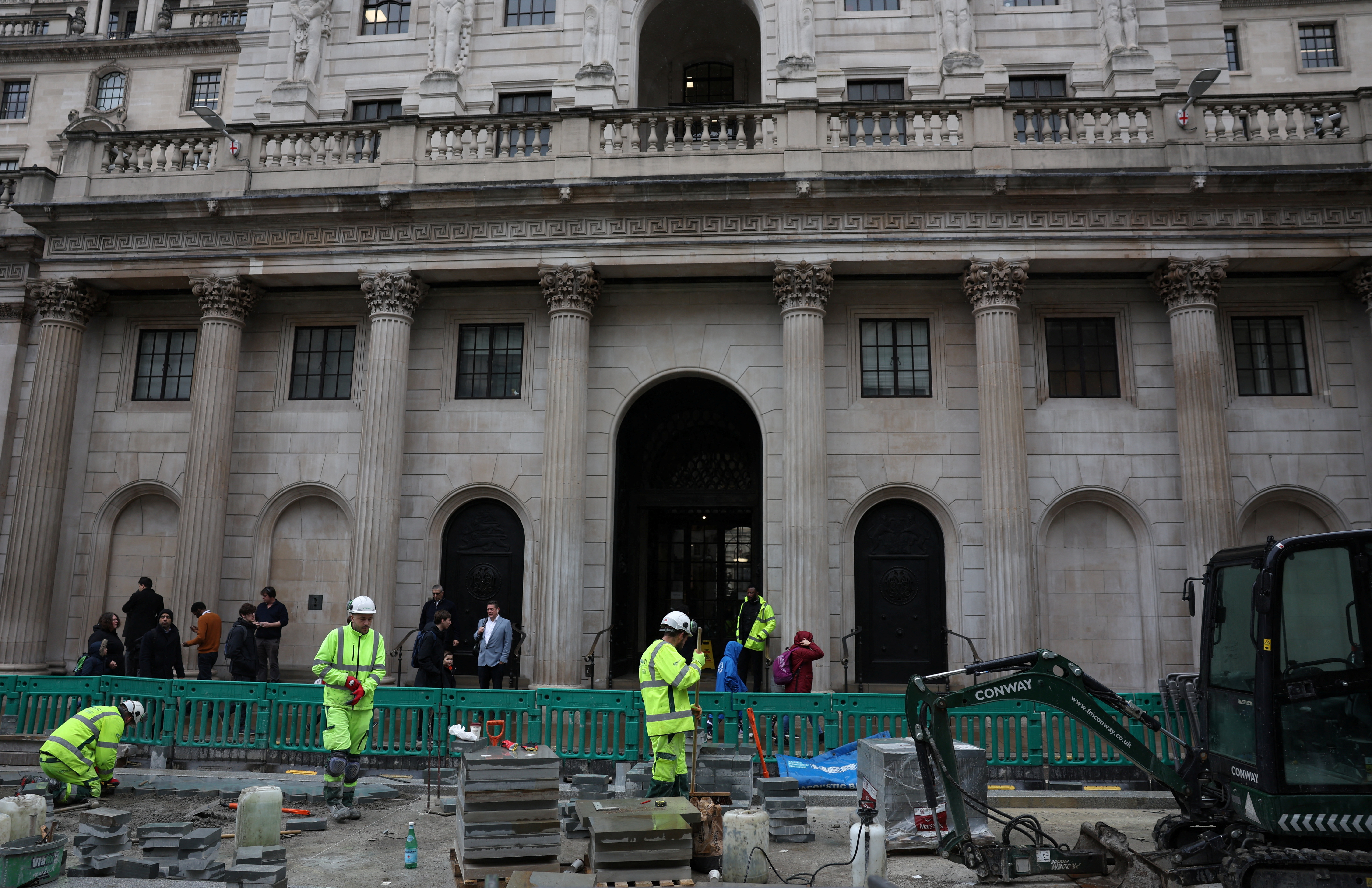 Road construction workers carry out work outside the Bank of England in the City of London financial district