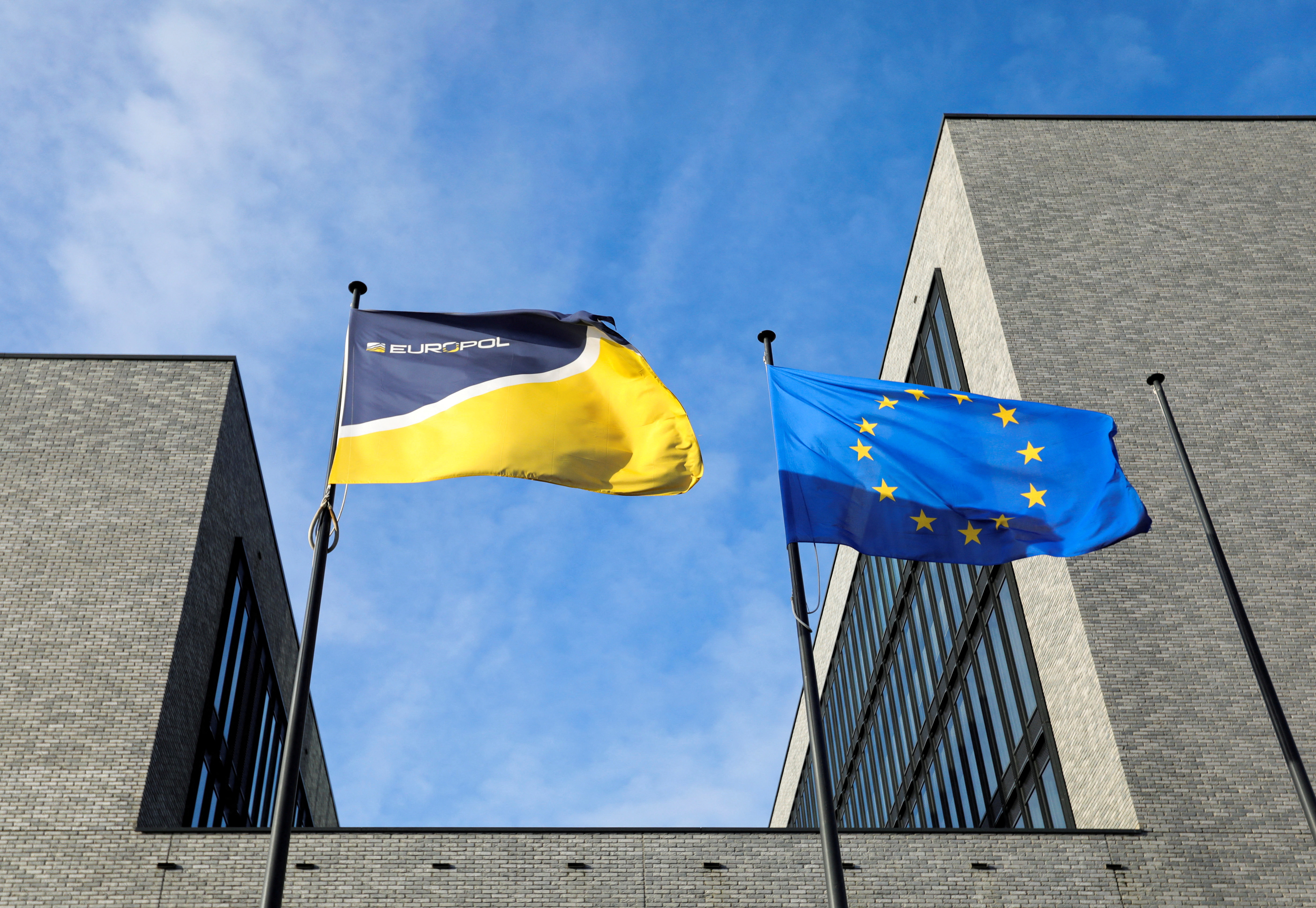 Flags flutter in front of the Europol building in The Hague