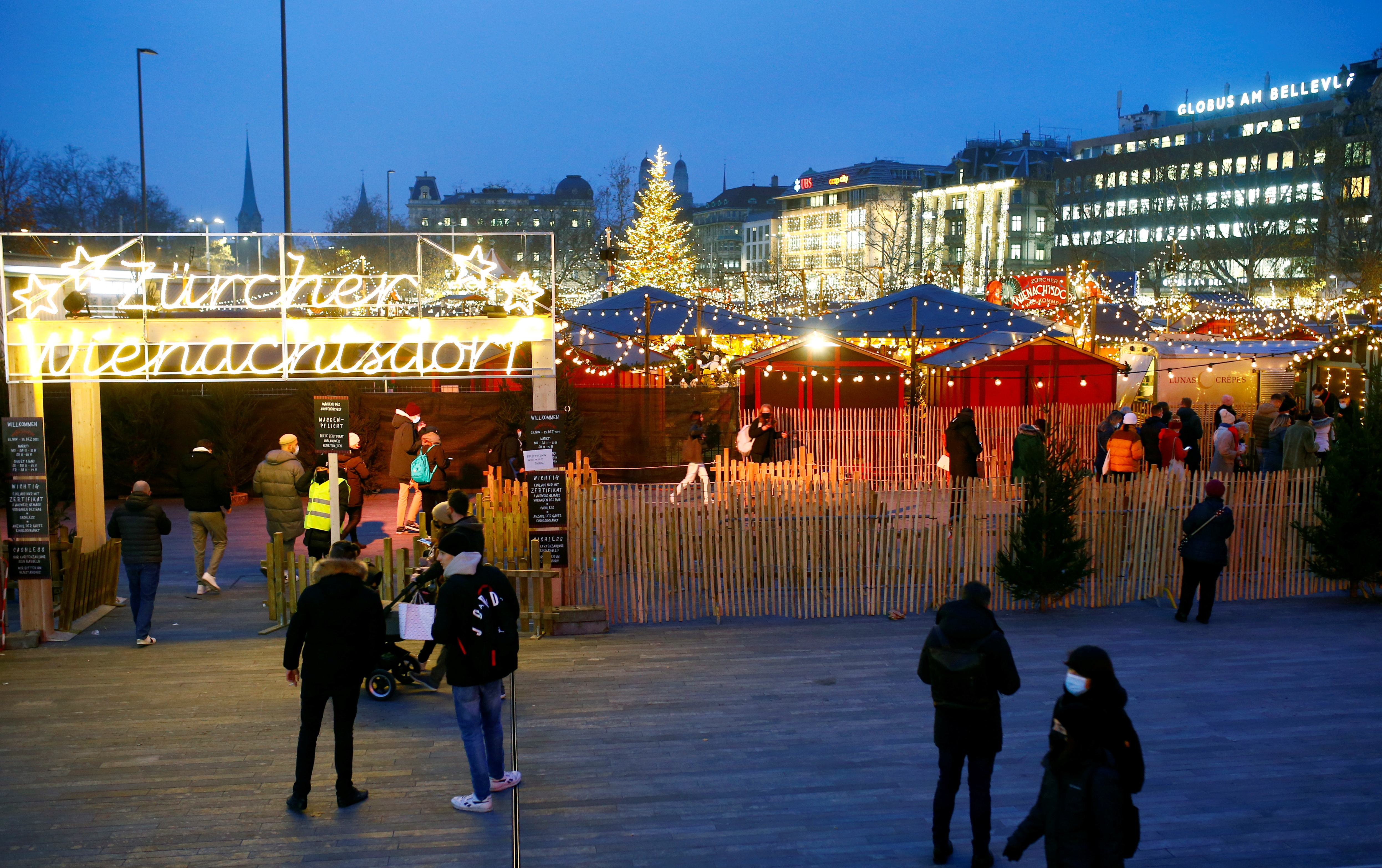 Visitors queue to check the COVID-19 health certificates at a Christmas market, in Zurich