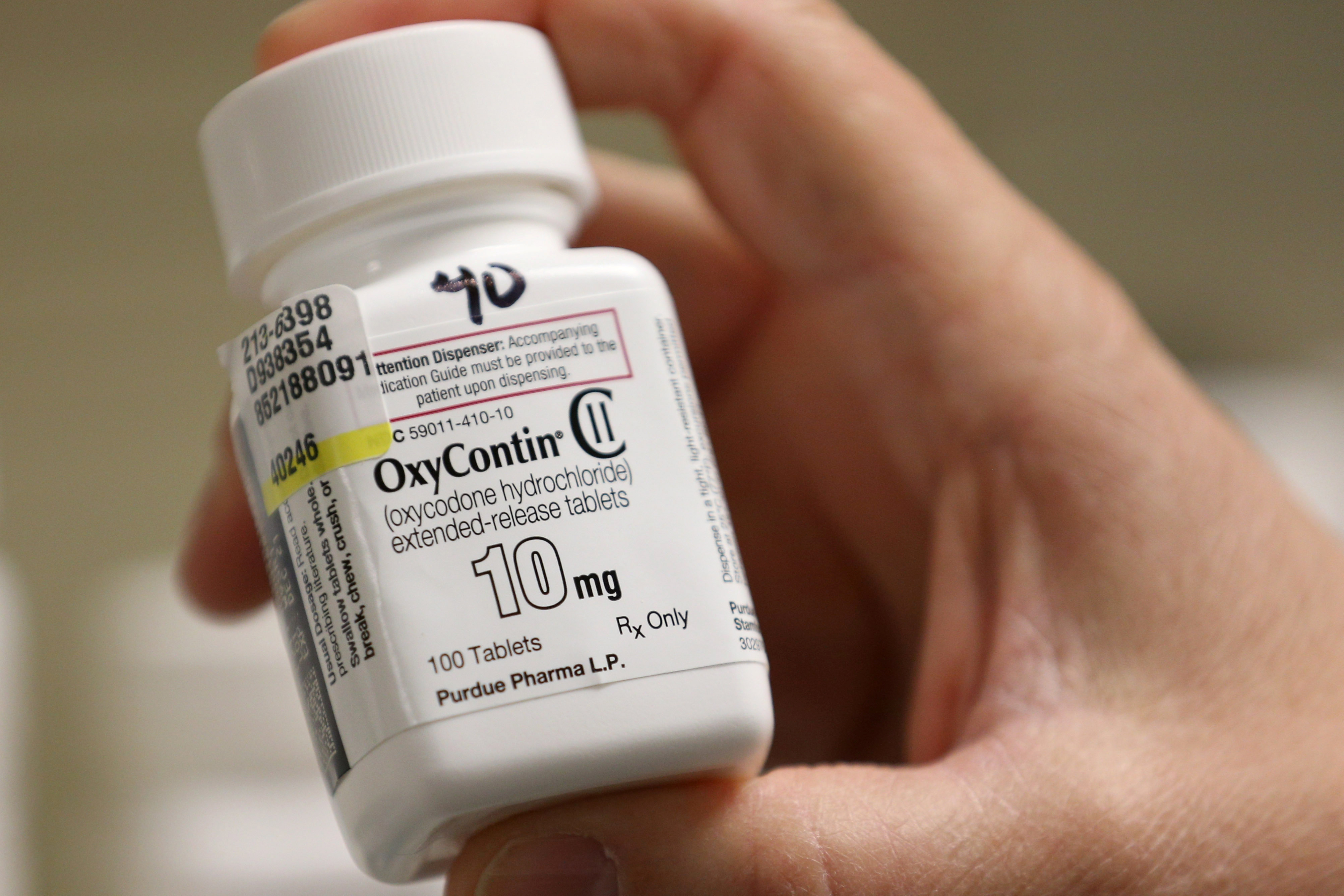 A pharmacist holds a bottle OxyContin made by Purdue Pharma at a pharmacy in Provo, Utah