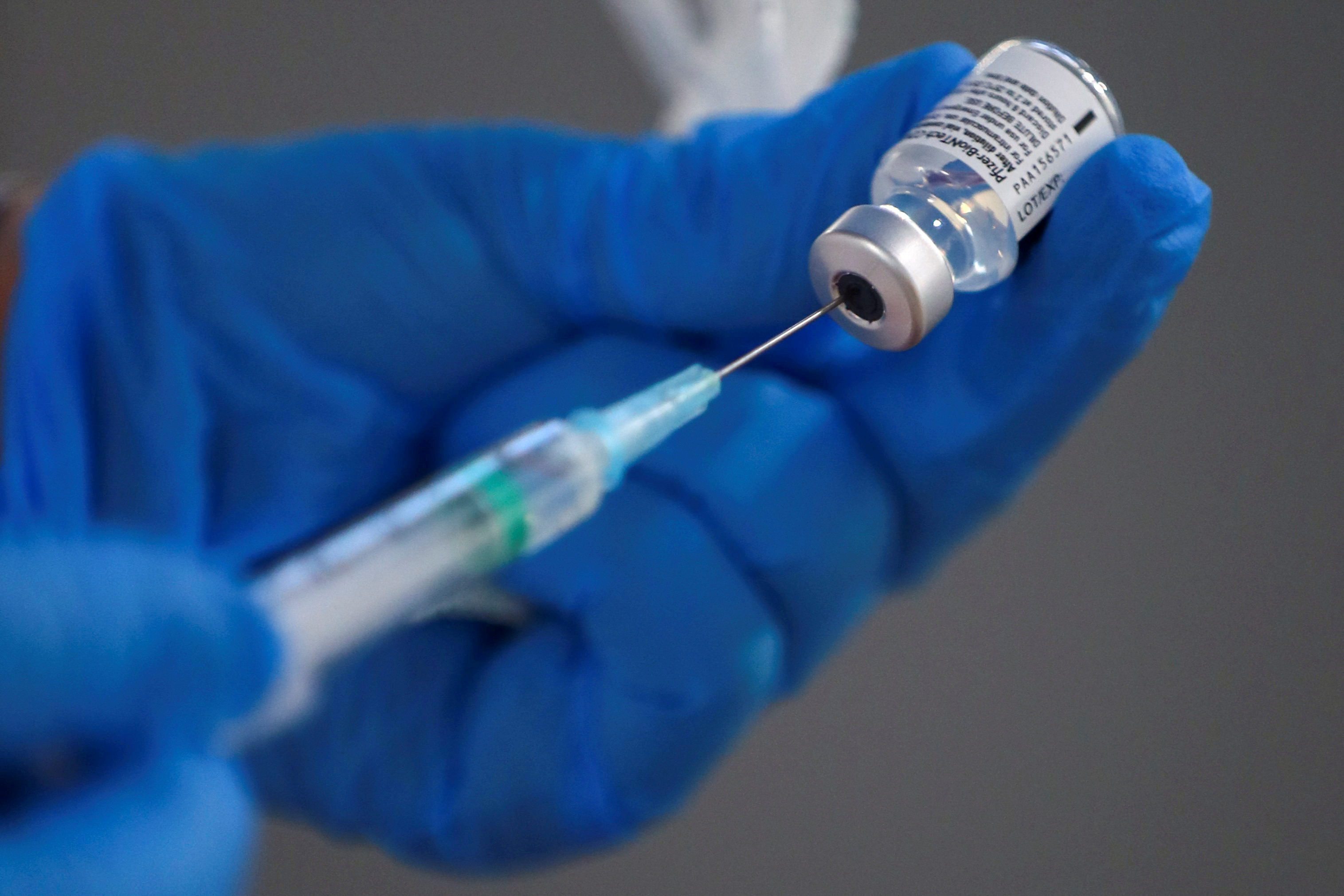 A nurse fills a syringe with a second dose of the Pfizer-BioNTech COVID-19 vaccine in Madrid