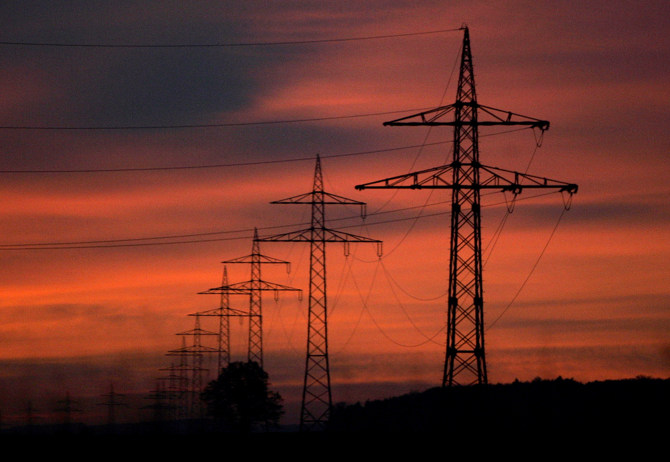 High-voltage power lines are seen during sunset near Ulm