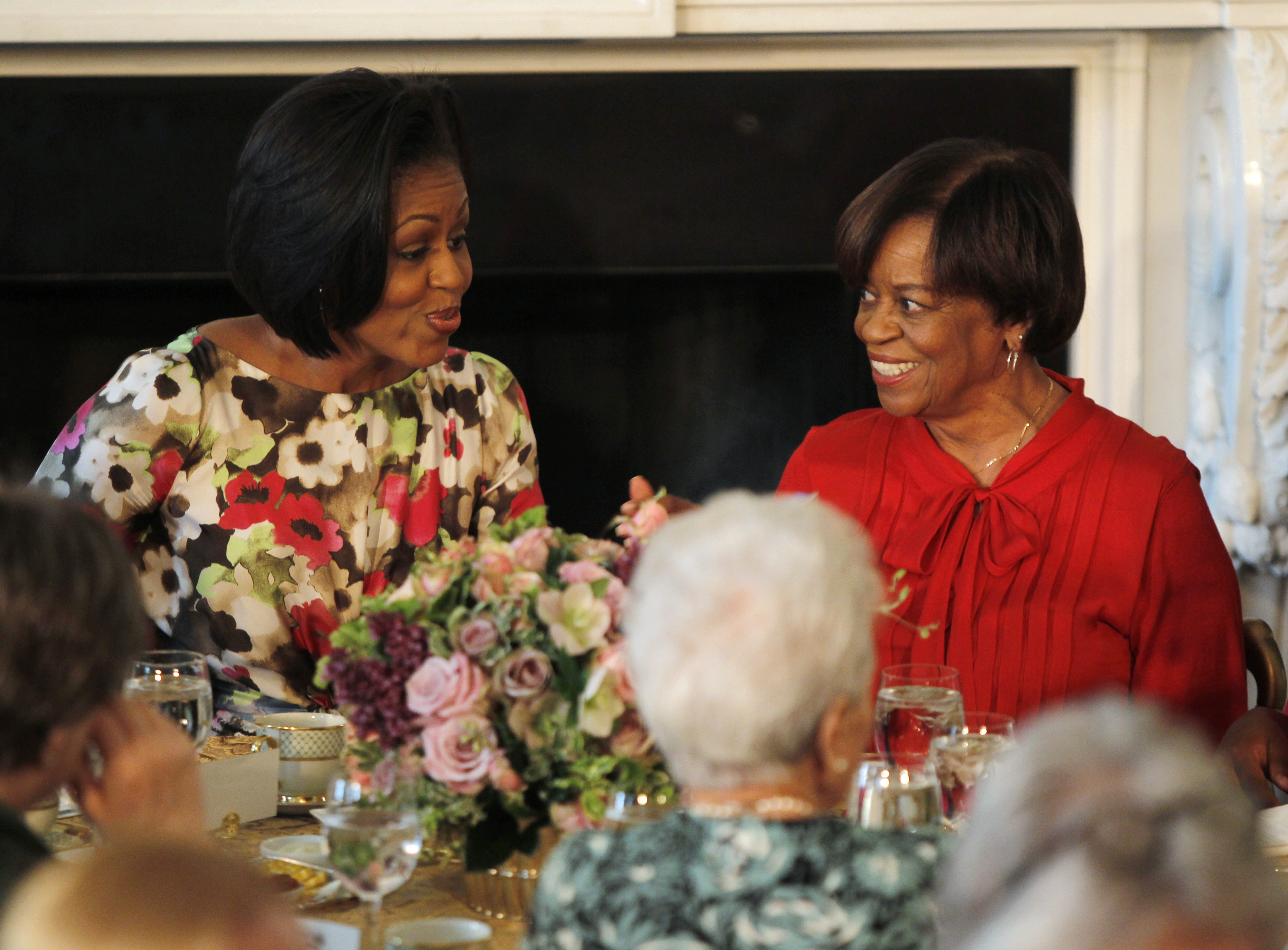 US first lady Obama sits alongside her mother Robinson as she hosts a Mother's Day event in Washington