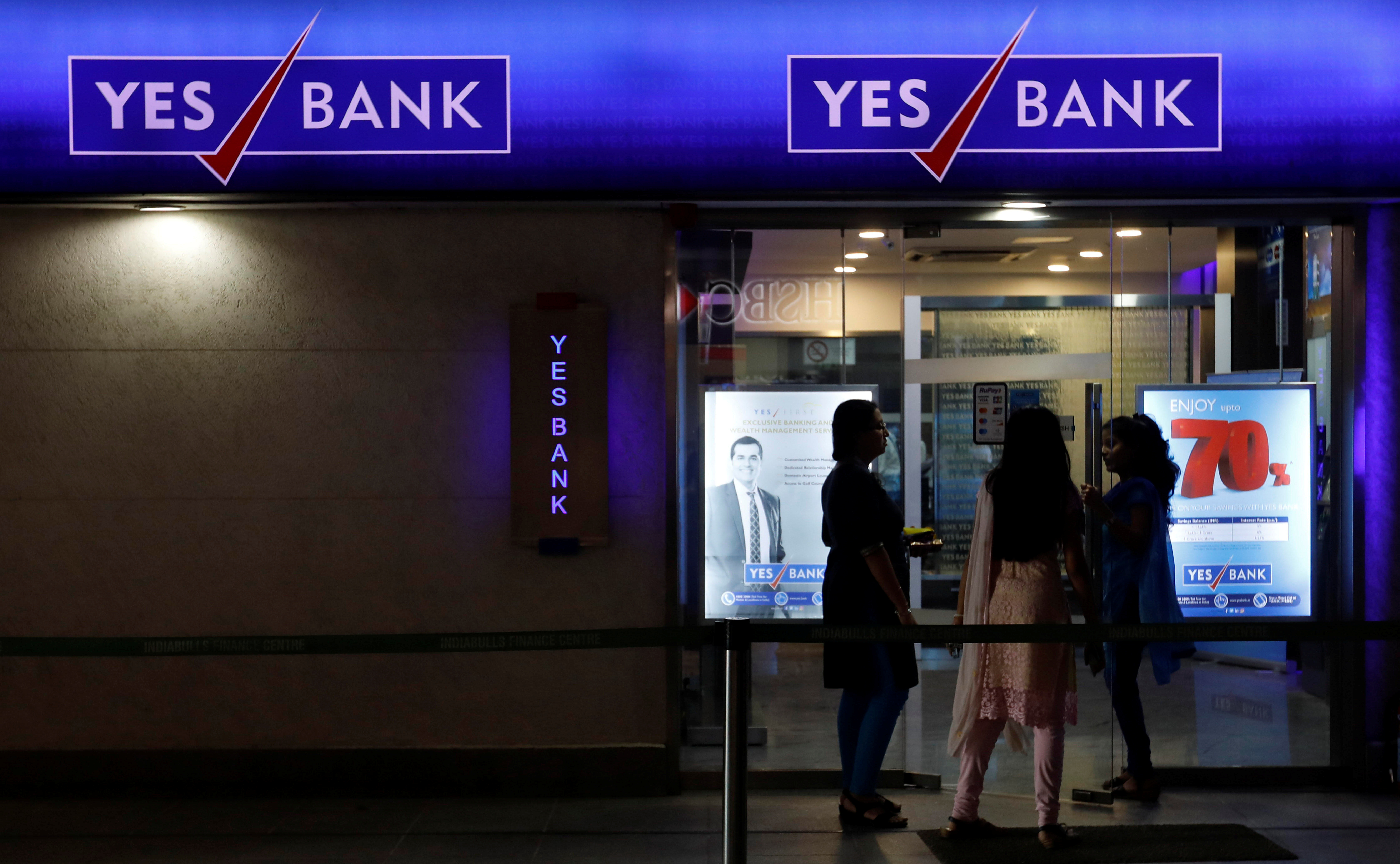 Employees enter a Yes Bank branch at its headquarters in Mumbai