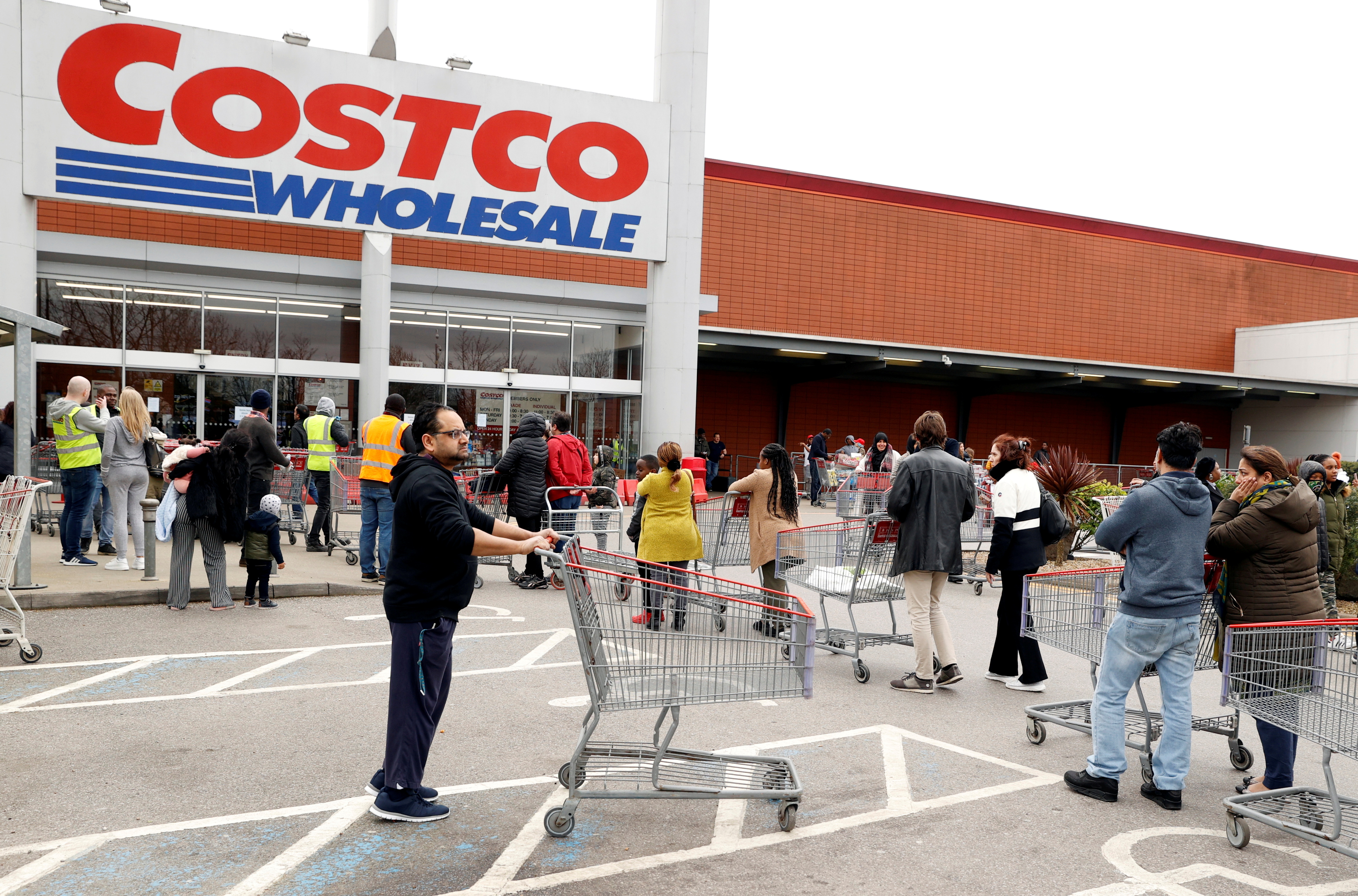 Customers queue to enter a Costco Wholesale store in Chingford