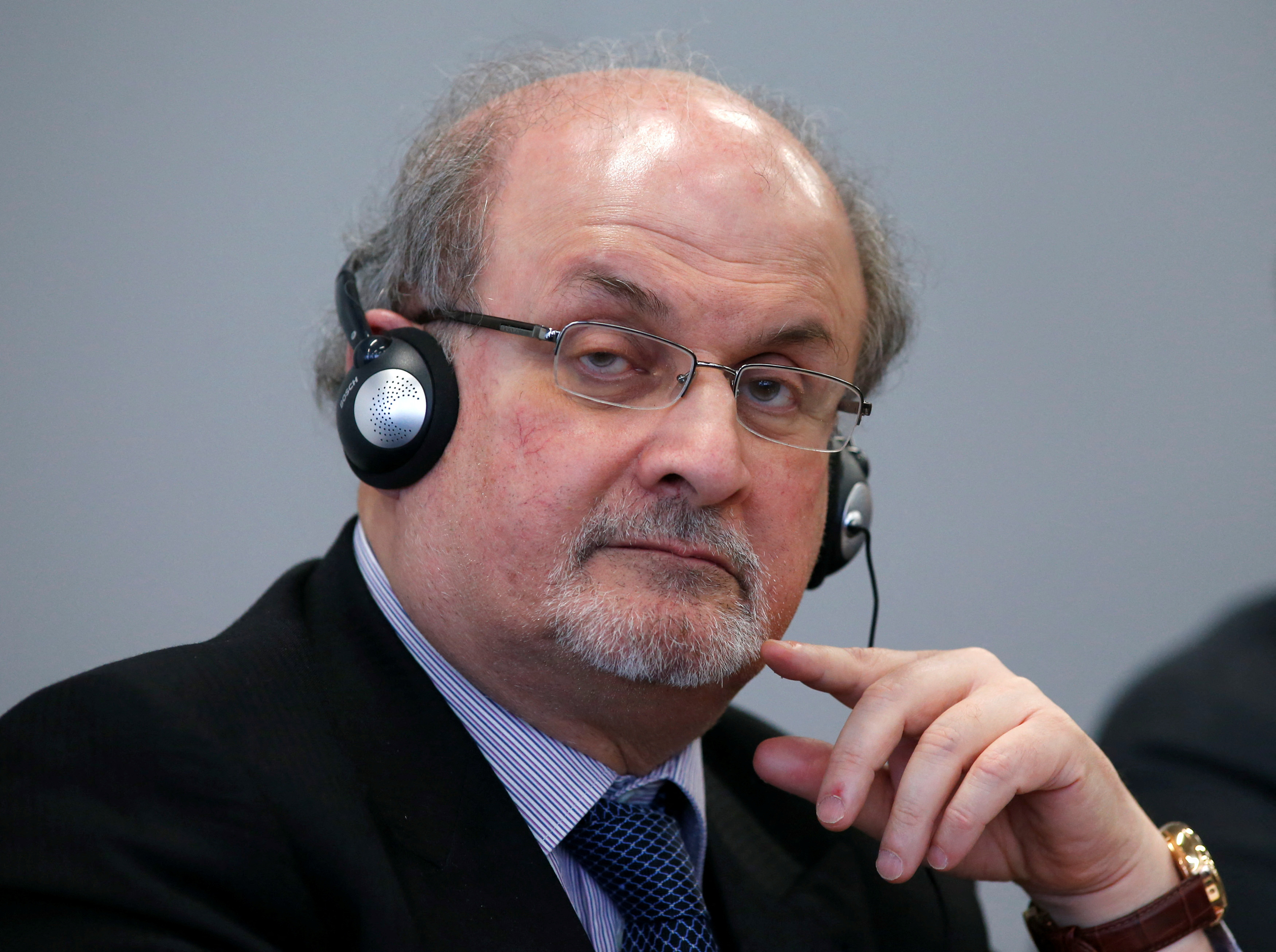 Author Rushdie listens during the opening news conference of the Frankfurt book fair