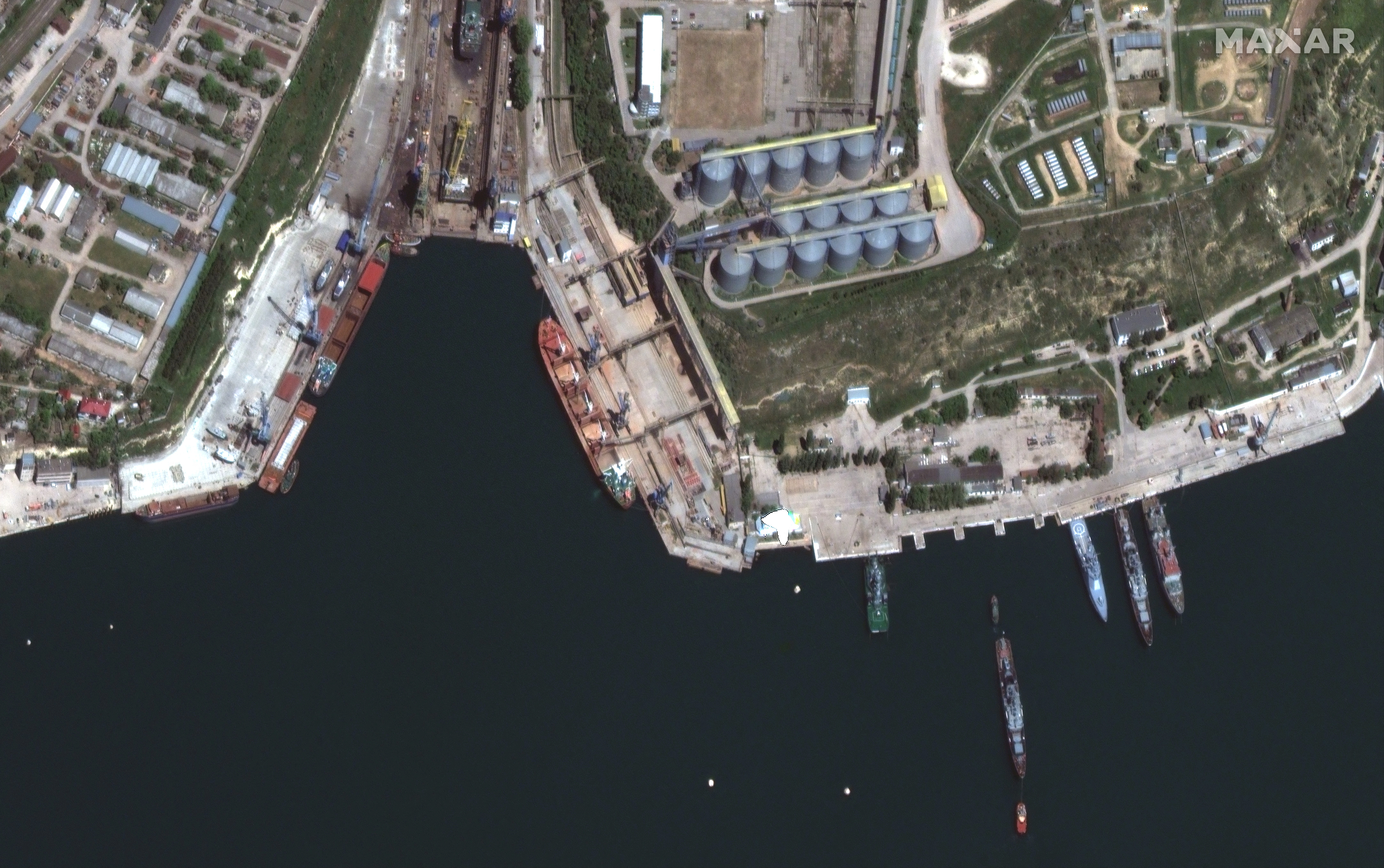 A satellite image shows a bulk carrier ship loading grain at the port of Sevastopol