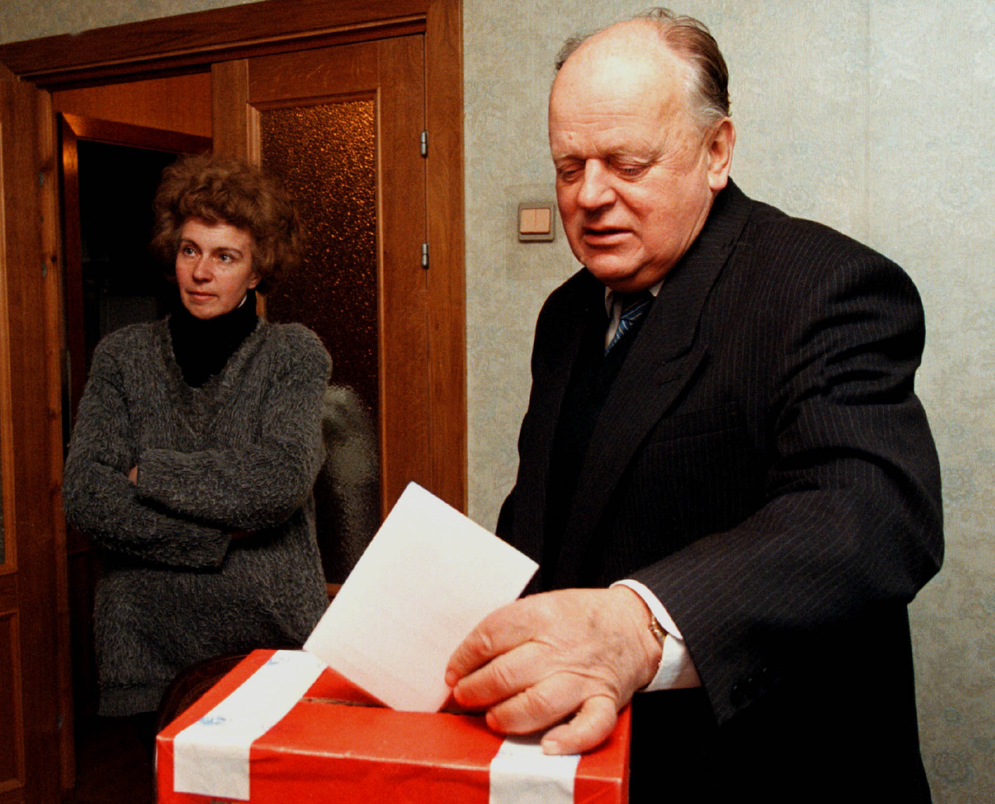 Former speaker of Belarussian parliament Stanislav Shushkevich drops his voting ballot in a box