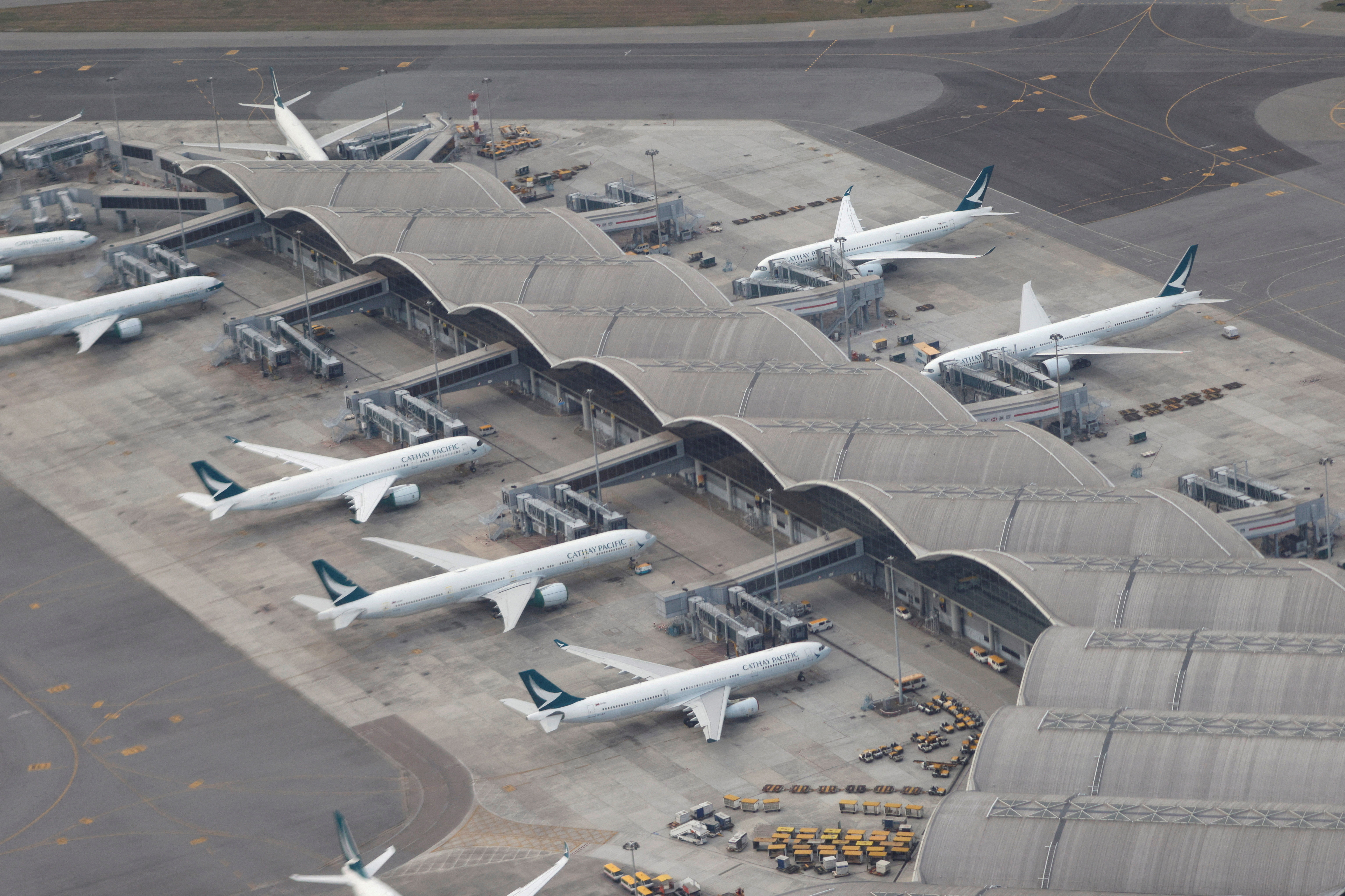 Aircraft of Cathay Pacific are parked on the tarmac at the Hong Kong International Airport, Hong Kong