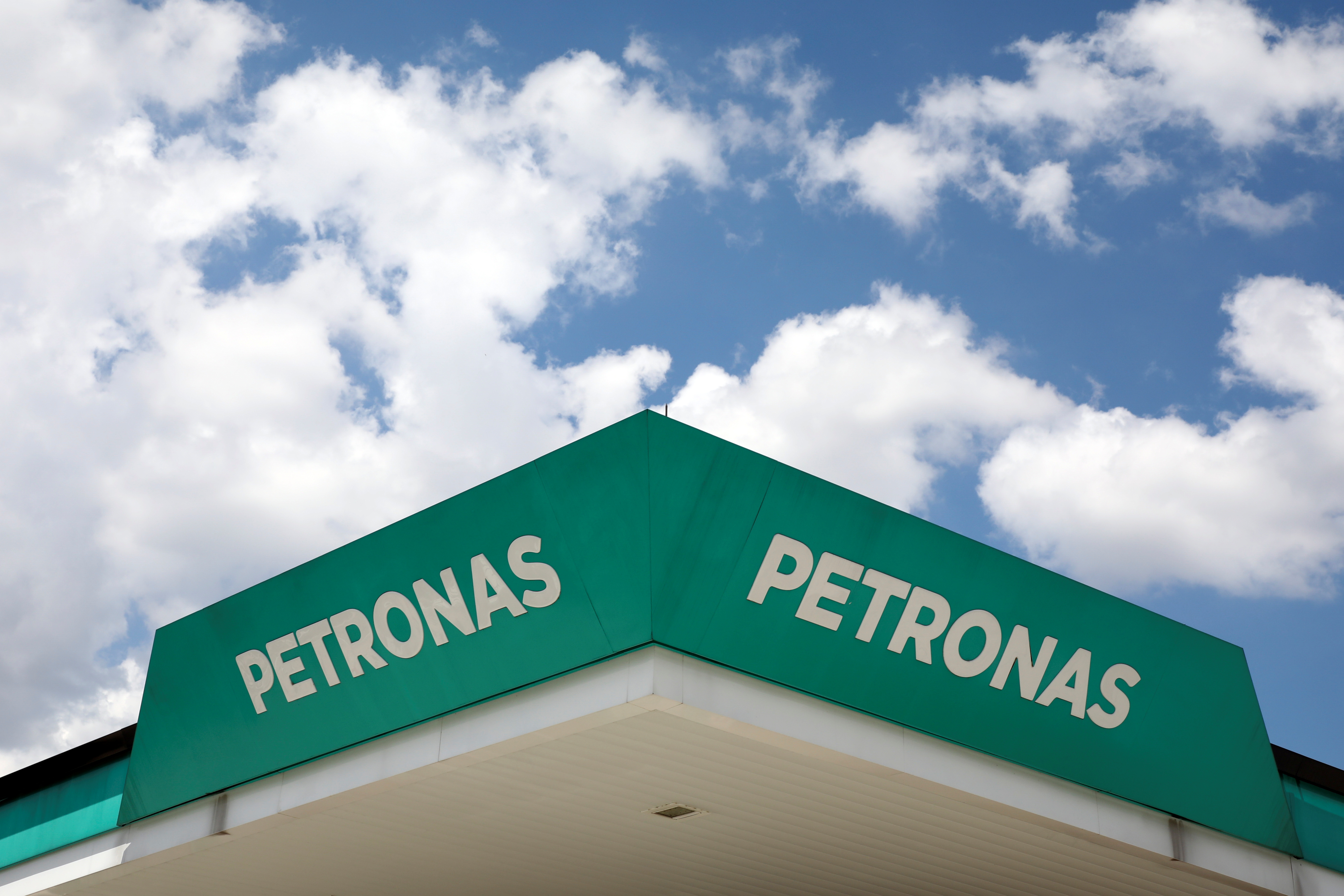 Petronas logos are pictured at a fuel station in Serdang