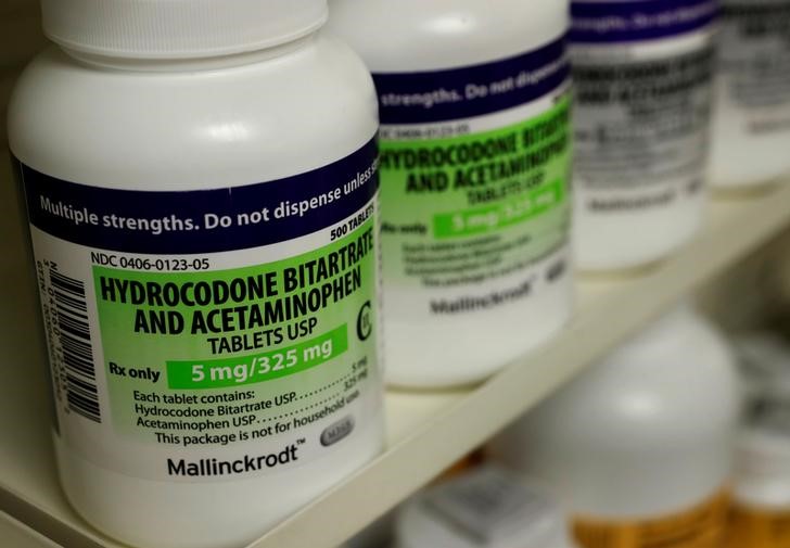Bottles of prescription painkillers Hydrocodine Bitartrate and Acetaminopohen, 5mg/325mg pills, made by Mallinckrodt sit on a shelf at a local pharmacy