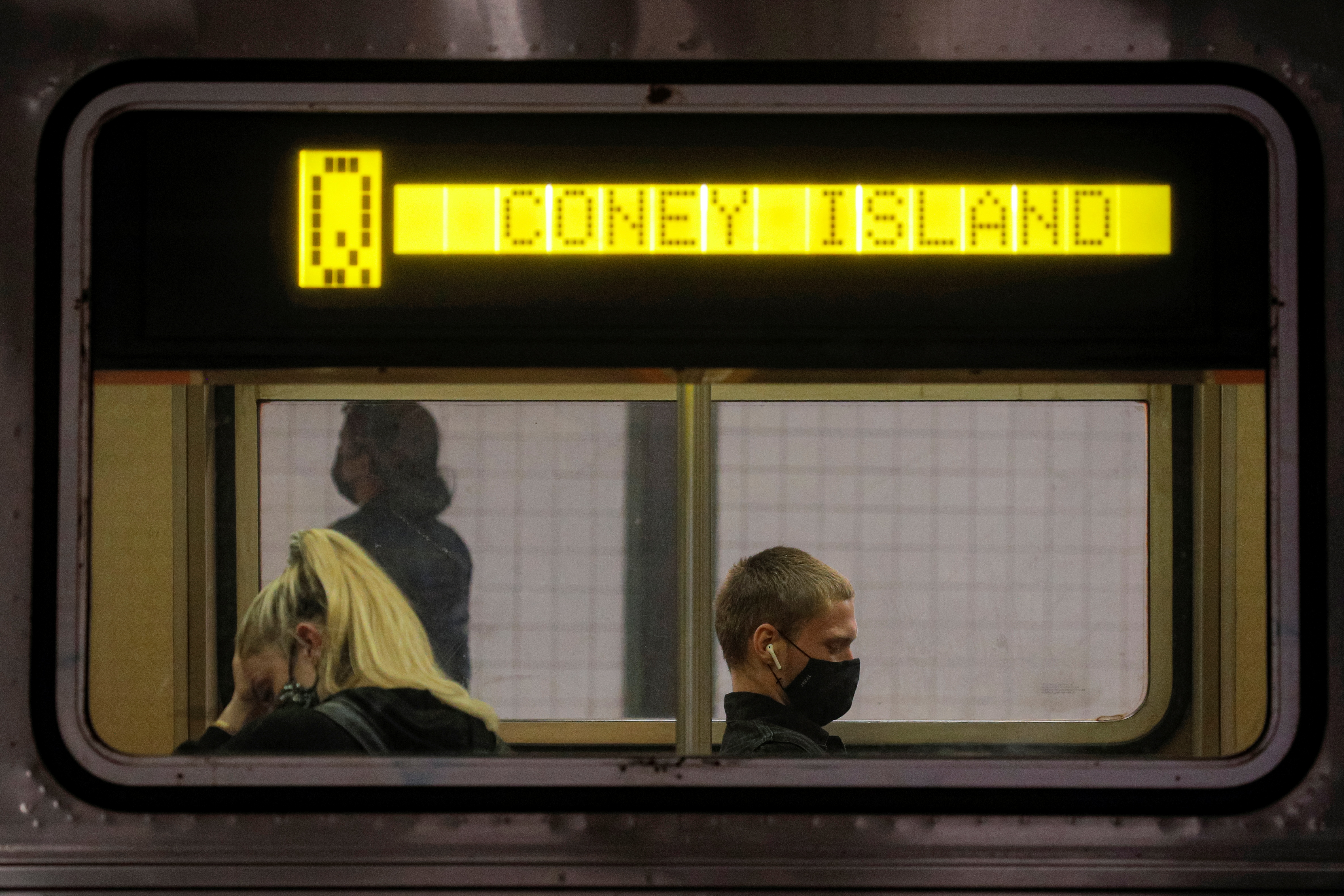 Passengers ride aboard the MTA's New York City Transit subway, in New York