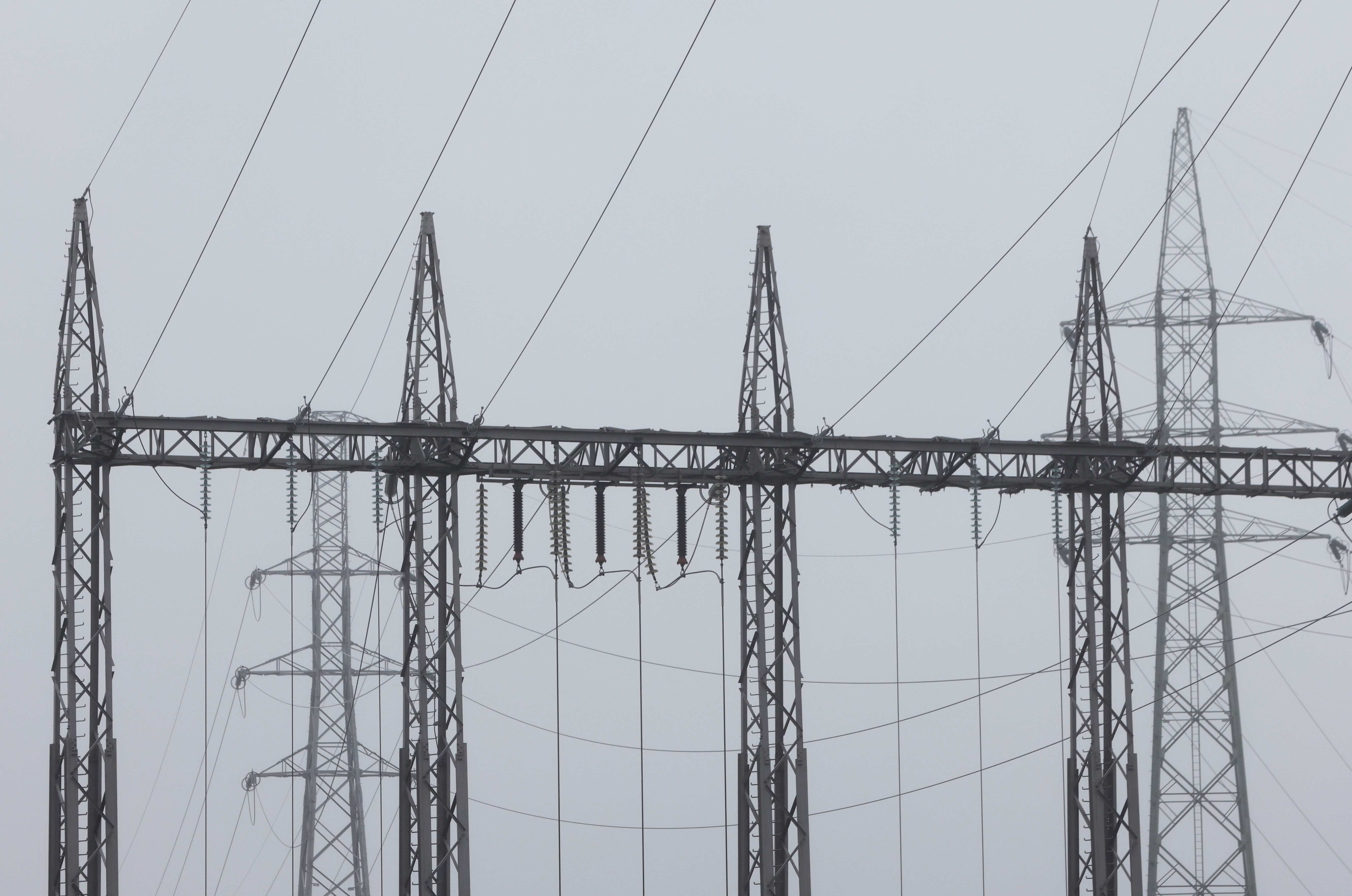 Electric pylons are seen at a combined-cycle gas turbine power plant in Drogenbos