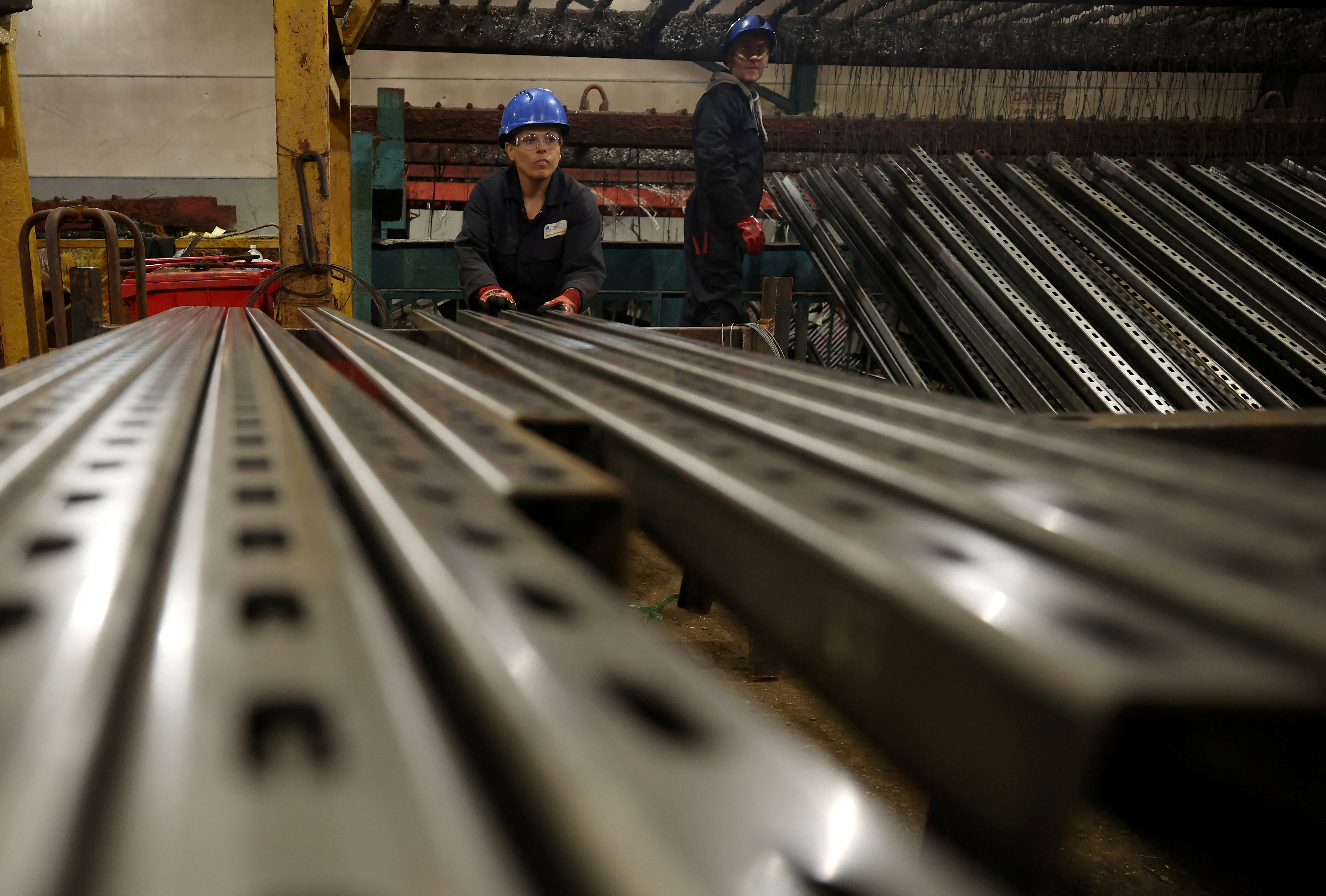 Worker prepares pieces of metal to be galvanised inside the factory of Corbetts The Galvanizers in Telford